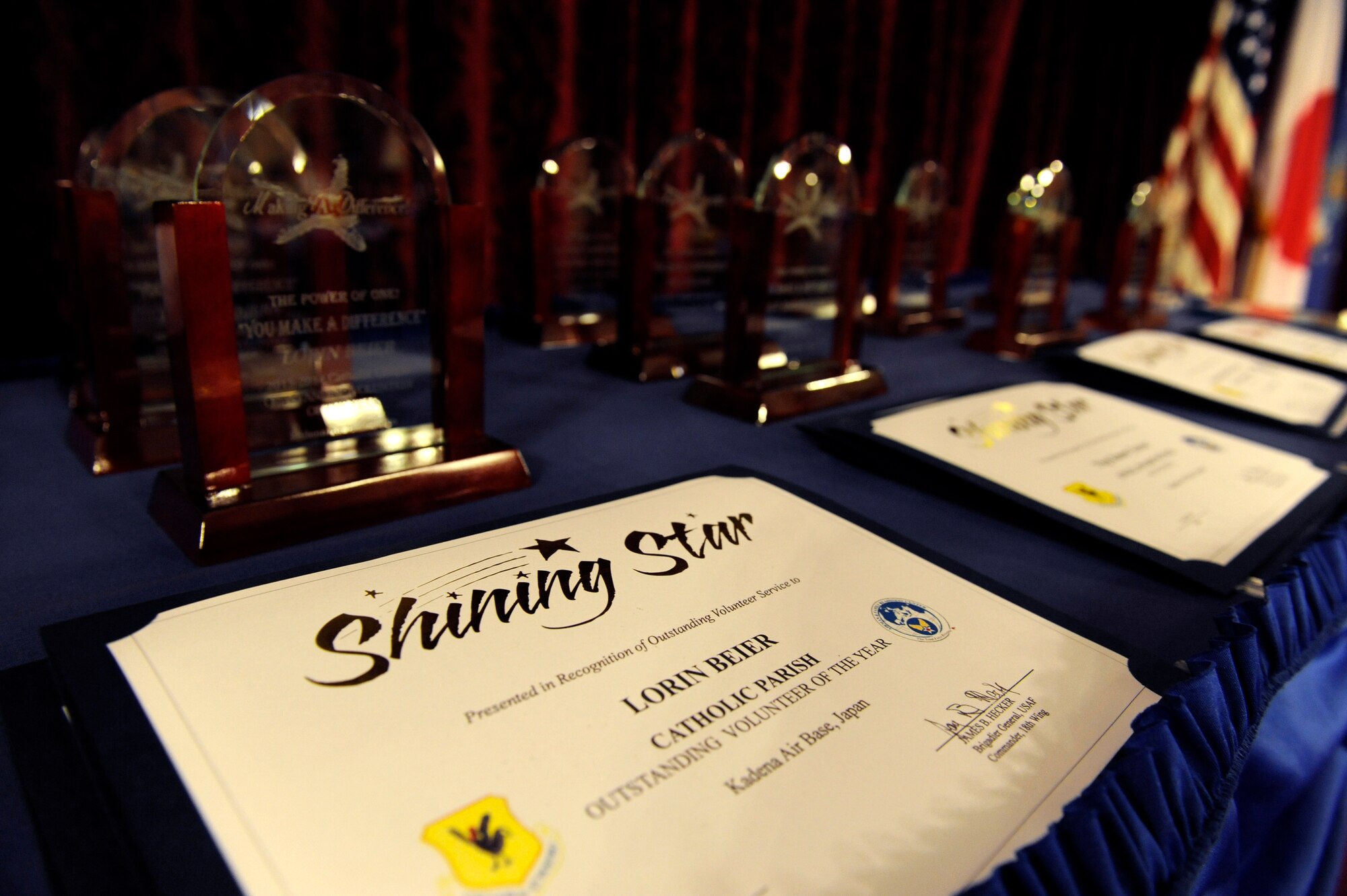 Awards and certificates are arranged to be given to winners during a volunteer recognition ceremony on Kadena Air Base, Japan, April 11, 2014. During the event, Kadena recognized more than 30 volunteers for a collective 563,771 hours to the Kadena community. In terms of minimum wage, the volunteers saved the Air Force a total of more than $12.8 million. (U.S. Air Force photo by Senior Airman Maeson L. Elleman)