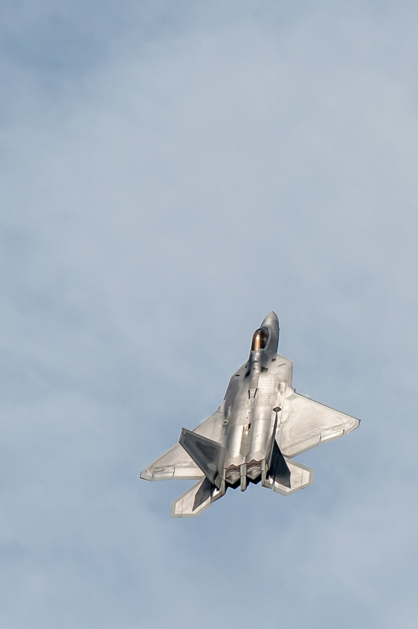 The pilot of a U.S. Air Force F-22 Raptor practices his aerial demonstration routine over the Ohio River in downtown Louisville, Ky., April 10, 2014. The F-22 is performing in this weekend's Thunder Over Louisville air show. (U.S. Air National Guard photo by Maj. Dale Greer)