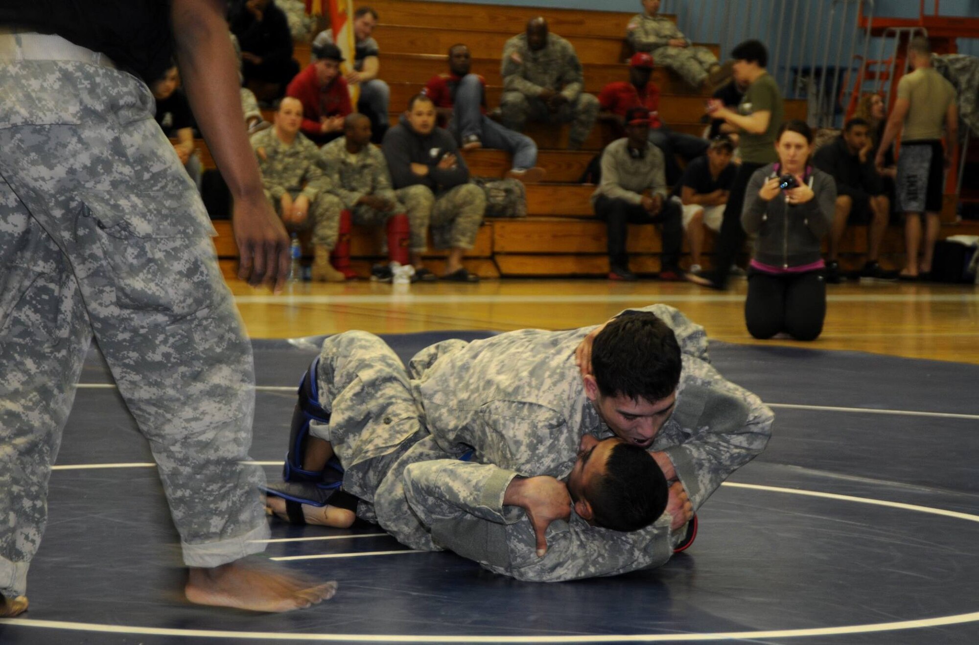 Army Pfc. Francisco Mesina [BOTTOM], a healthcare specialist assigned to 6-52 Air Defense Artillery Battalion, grapples with another flyweight competitor in the Eighth Army combatives tournament held April 4 in Yongsan. Mesina placed second in the flyweight division. (Photo courtesy of Eighth Army public affairs)