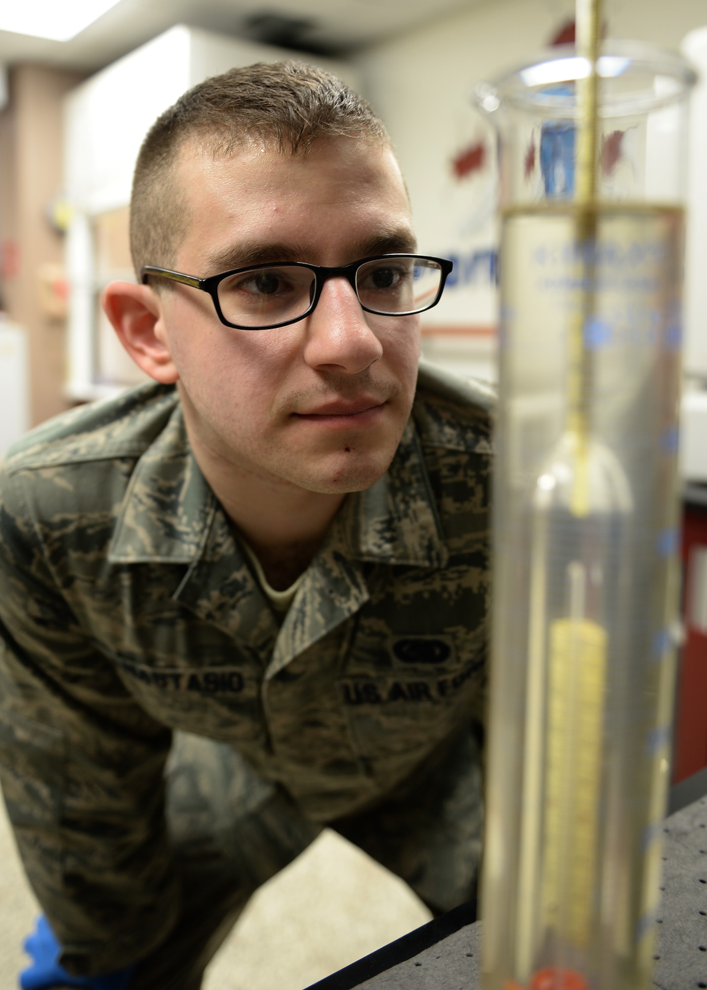 Senior Airman David Anastasio, 354th Logistic Readiness Squadron fuels lab technician, uses a hydrometer in a test tube full of jet fuel to measure gravity April 10, 2014, Eielson Air Force Base, Alaska. The test shows what additives need to be supplemented into the fuel for proper performance. (U.S. Air Force photo by Staff Sgt. Shawn Nickel/Released)