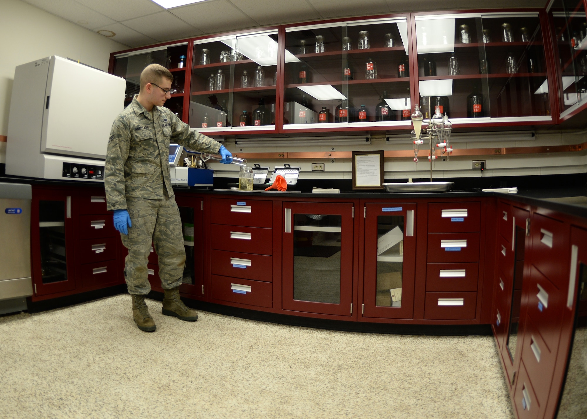 Senior Airman David Anastasio, 354th Logistic Readiness Squadron fuels lab technician, adds a sample to a jar, to test the gravity of the fuel April 10, 2014, Eielson Air Force Base, Alaska. Technicians test up to 10 samples per day for water, particulate matter, gravity and other important factors. (U.S. Air Force photo by Staff Sgt. Shawn Nickel/Released)