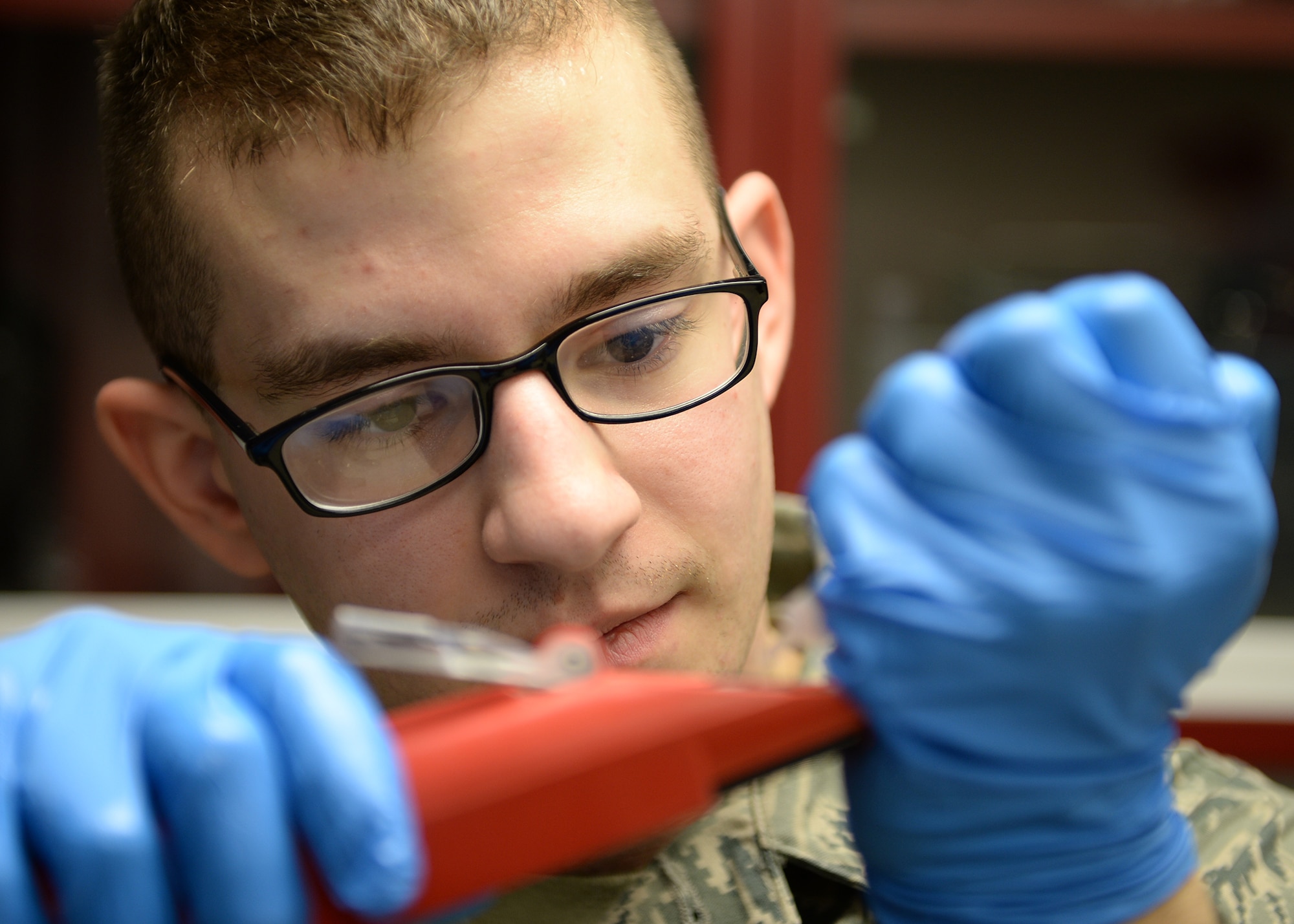 Senior Airman David Anastasio, 354th Logistic Readiness Squadron fuels lab technician, adds a sample to a meter, which will test water levels in fuel April 10, 2014, Eielson Air Force Base, Alaska. The test will show the effectiveness of additives by separating water in the fuel. (U.S. Air Force photo by Staff Sgt. Shawn Nickel/Released)