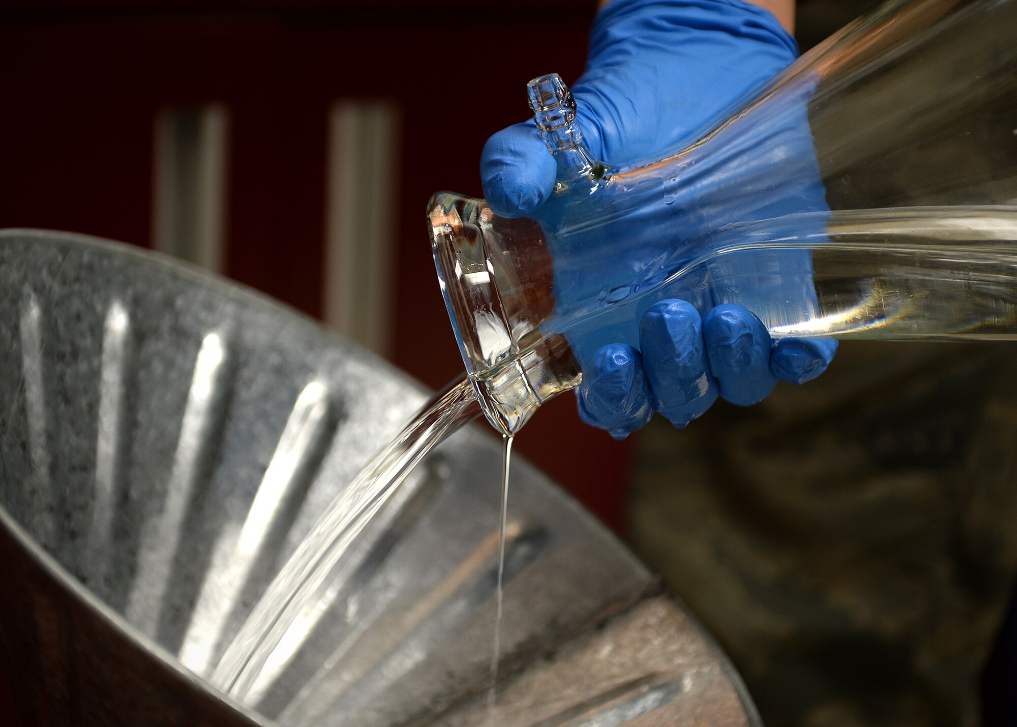 Senior Airman David Anastasio, 354th Logistic Readiness Squadron fuels lab technician, pours fuel into a bowser April 10, 2014, Eielson Air Force Base, Alaska. After testing, all fuel is recycled or returned to the tank for use ensuring none is wasted. (U.S. Air Force photo by Staff Sgt. Shawn Nickel/Released)