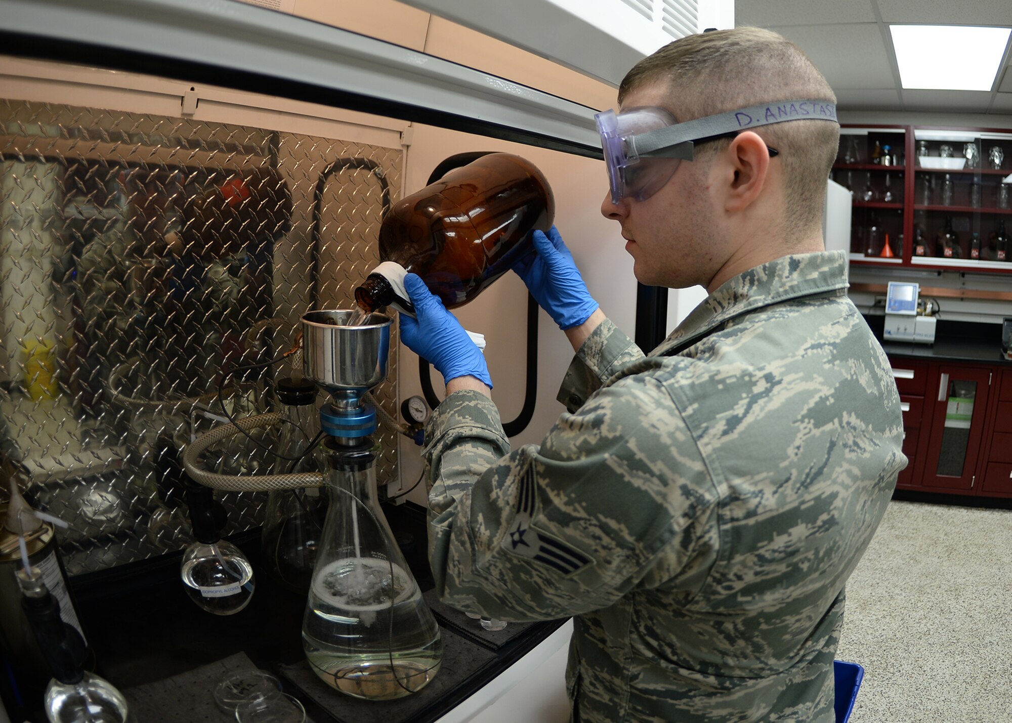 Senior Airman David Anastasio, 354th Logistic Readiness Squadron fuels lab technician, uses the bottle method to test jet fuel for particulate matter April 10, 2014, Eielson Air Force Base, Alaska. Technicians test up to 10 samples per day for water, particulate matter, gravity and other important factors. (U.S. Air Force photo by Staff Sgt. Shawn Nickel/Released)