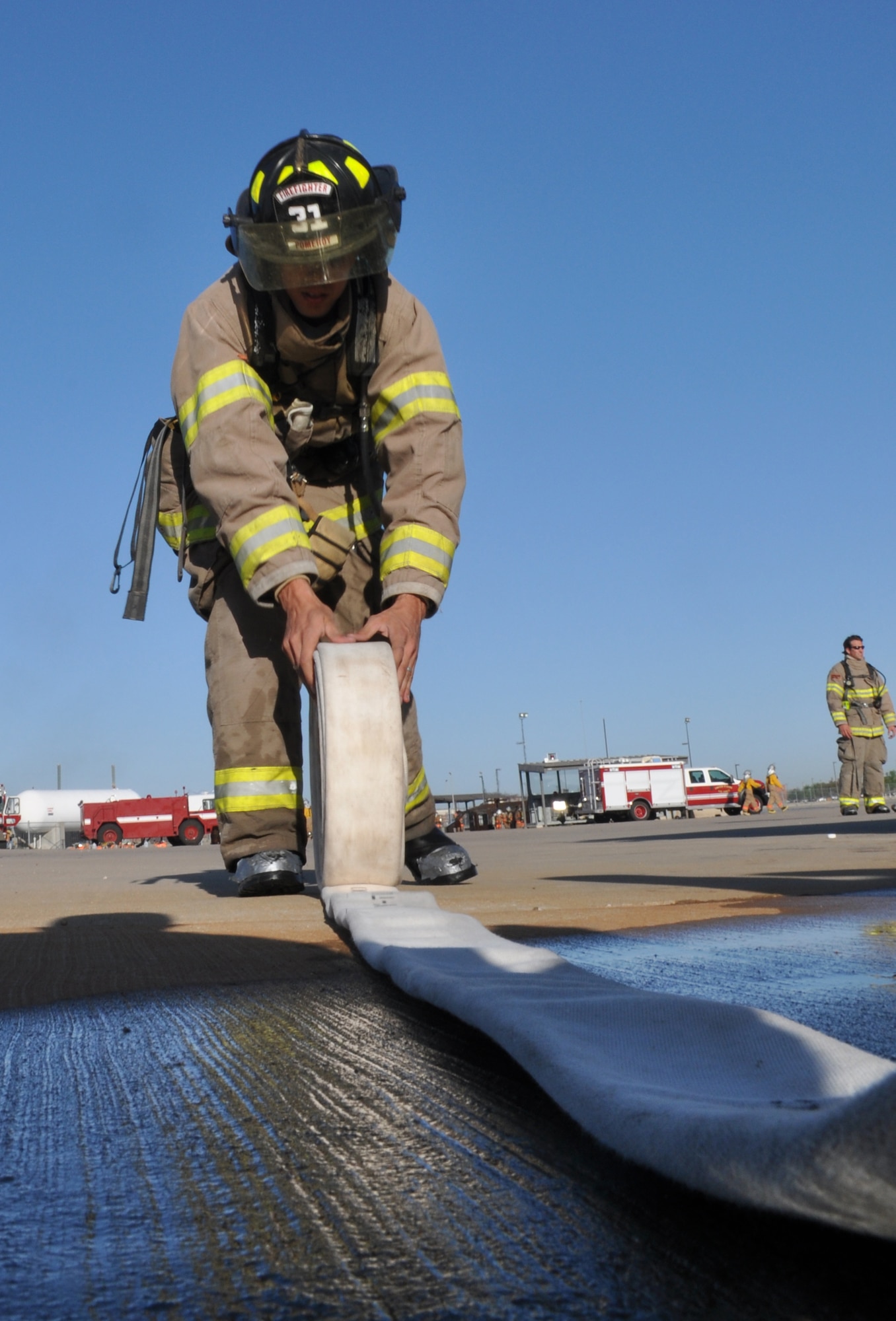GOODFELLOW AIR FORCE BASE, Texas - Benjamin P. Coder, San Angelo Fire Department recruit, rolls a hose at the Louis F. Garland Department of Defense Fire Academy here April 9. Proper tool maintenance and accountability are important factors for firefighter dealing with potential life-threatening risks. (U.S. Air Force photo/ Senior Airman Joshua Edwards)