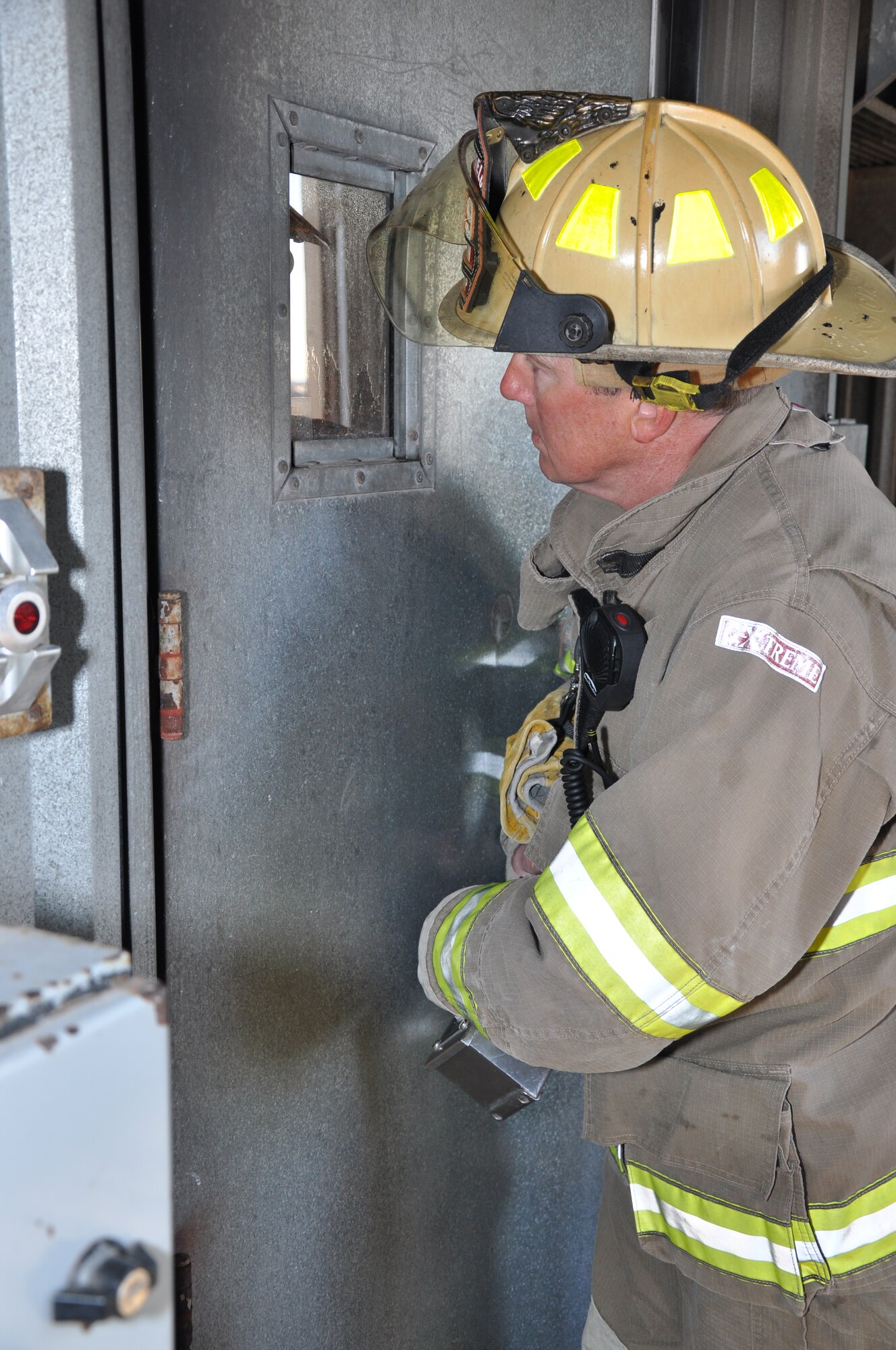 GOODFELLOW AIR FORCE BASE, Texas - Capt. M. Wade Millsap, San Angelo Fire Department safety officer, watches a group of recruits fight a fire at the Louis F. Garland Department of Defense Fire Academy here April 8. Once the recruits performed a task correctly, Millsap would shut off the propane to different parts of the stove fire. (U.S. Air Force photo/ Senior Airman Joshua Edwards)