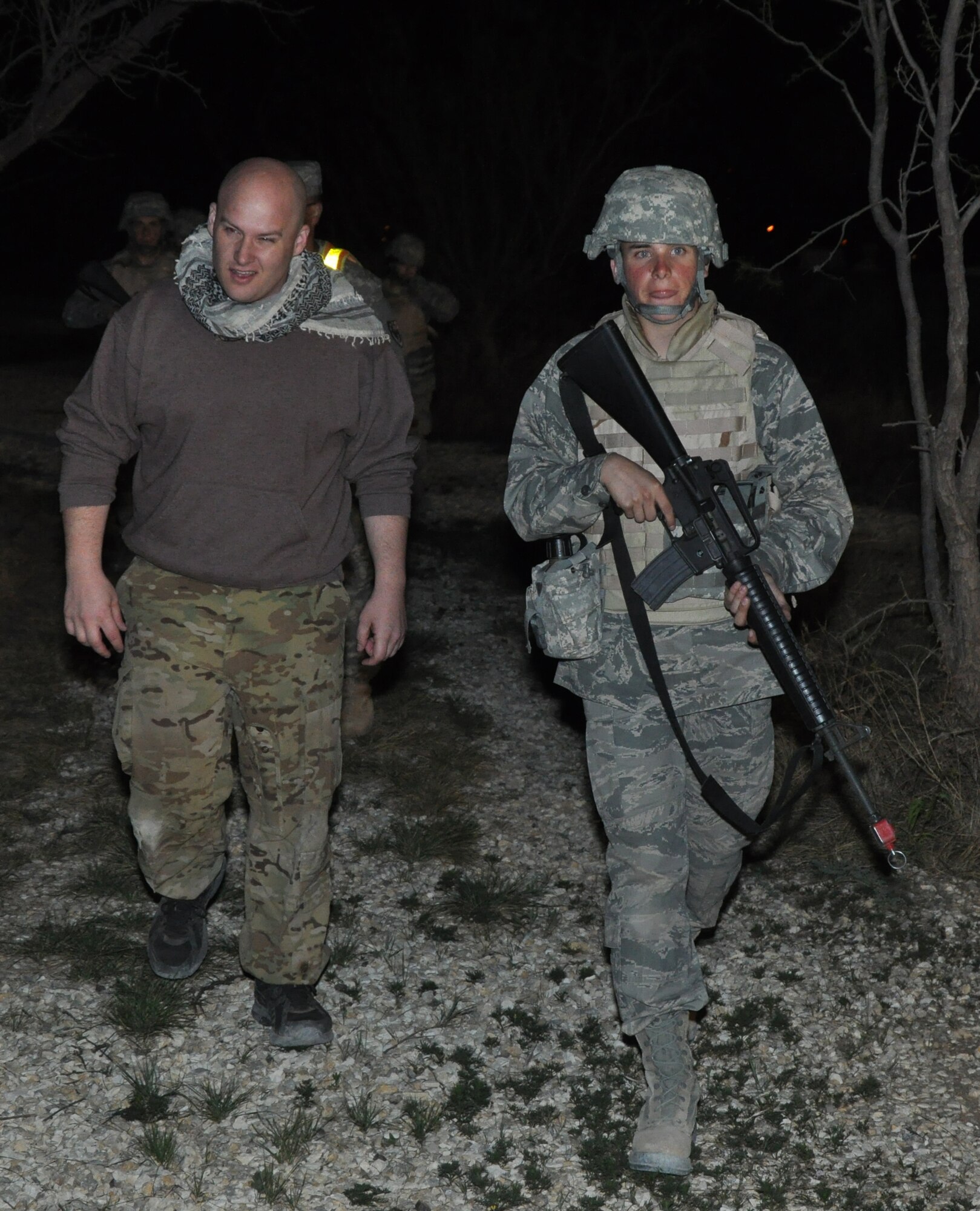 GOODFELLOW AIR FORCE BASE, Texas – Cadet Matthew D. Cornman, Angelo State University Air Force ROTC Detachment 847 student, escorts a role player back to his farm during a field training exercise at Camp Sentinel here April 4. This was one of a dozen occurrences that took place to include detaining prisoners, providing medical treatment and dealing with a mob. (U.S. Air Force photo/ Senior Airman Joshua Edwards) 