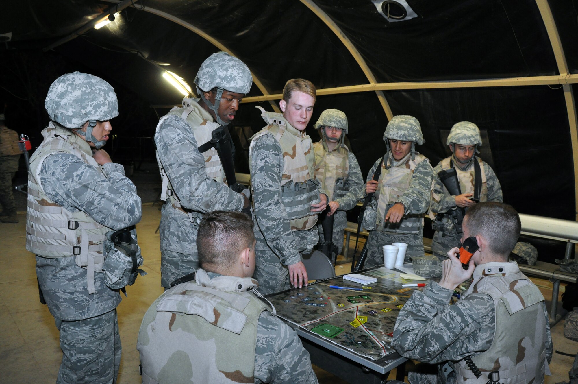 GOODFELLOW AIR FORCE BASE, Texas – Before starting their patrol shift, Angelo State University Air Force ROTC Detachment 847 students gather intelligence during a field training exercise at Camp Sentinel here April 4. The patrol was never completed because the patrol was called to respond to an incident at the Camp Sentinel entry point. (U.S. Air Force photo/ Senior Airman Joshua Edwards)