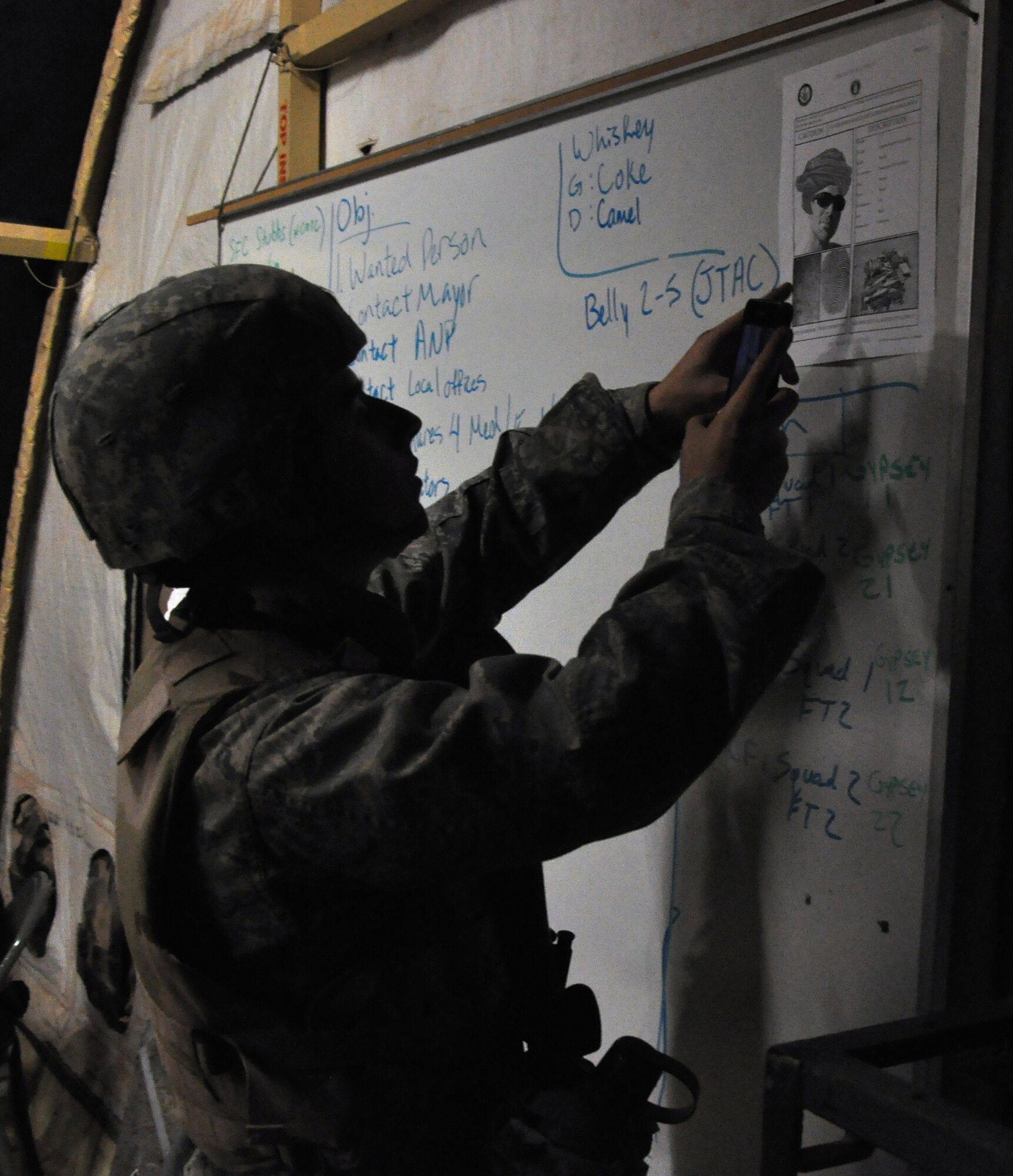 GOODFELLOW AIR FORCE BASE, Texas – Cadet Michael A. Degan-Matas, Angelo State University Air Force ROTC Detachment 847 student, uses his phone to take a photo of a suspect to use in the field during a field training exercise at Camp Sentinel here April 4. Degan-Matas used the photo and intelligence from a brief to help search for a role-playing terrorist. (U.S. Air Force photo/ Senior Airman Joshua Edwards)