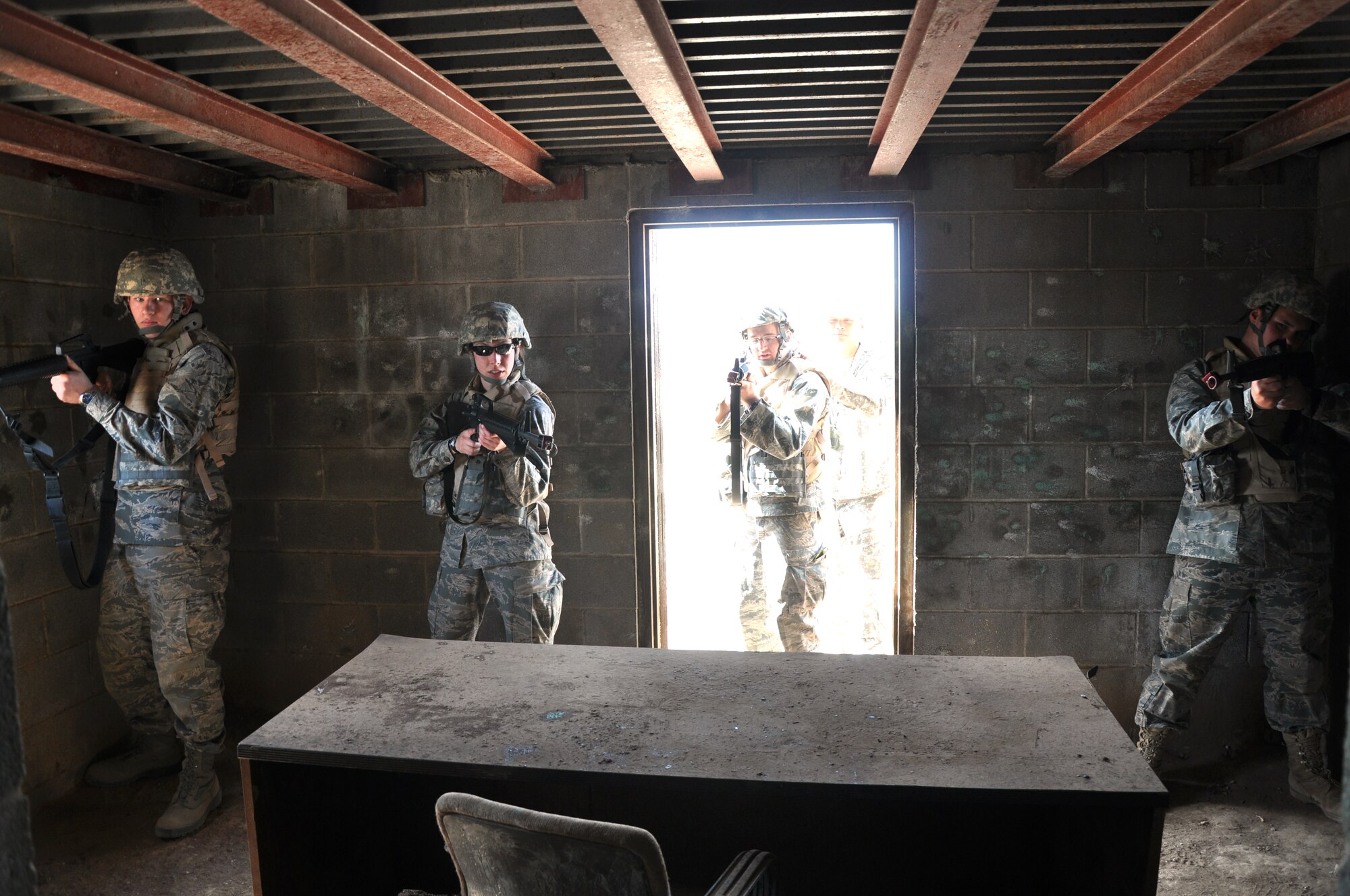 GOODFELLOW AIR FORCE BASE, Texas – Crimson Firing Squad, Angelo State University Air Force ROTC Detachment 847 students, learn to clear a multi-room building during a field training exercise at a deployed simulation village near Camp Sentinel here April 4. Army Sergeant 1st Class Albert L. Lazatin, Army 344th Military Intelligence Battalion warrior training team, taught the students to switch hands while holding their weapons when peaking around corners to reveal as little of their bodies as possible. (U.S. Air Force photo/ Senior Airman Joshua Edwards)
