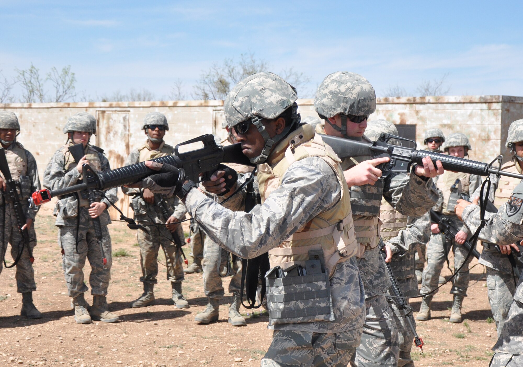 GOODFELLOW AIR FORCE BASE, Texas – Cadet Reggie B. Wilder, Angelo State University Air Force ROTC Detachment 847 student, and Chance D. Aycock, ASU ROTC cadet, learn room clearing movements during a field training exercise at a deployed simulation village near Camp Sentinel here April 4. After learning the basics, the cadets broke down into their fire teams and practiced clearing multi-room buildings. (U.S. Air Force photo/ Senior Airman Joshua Edwards) 