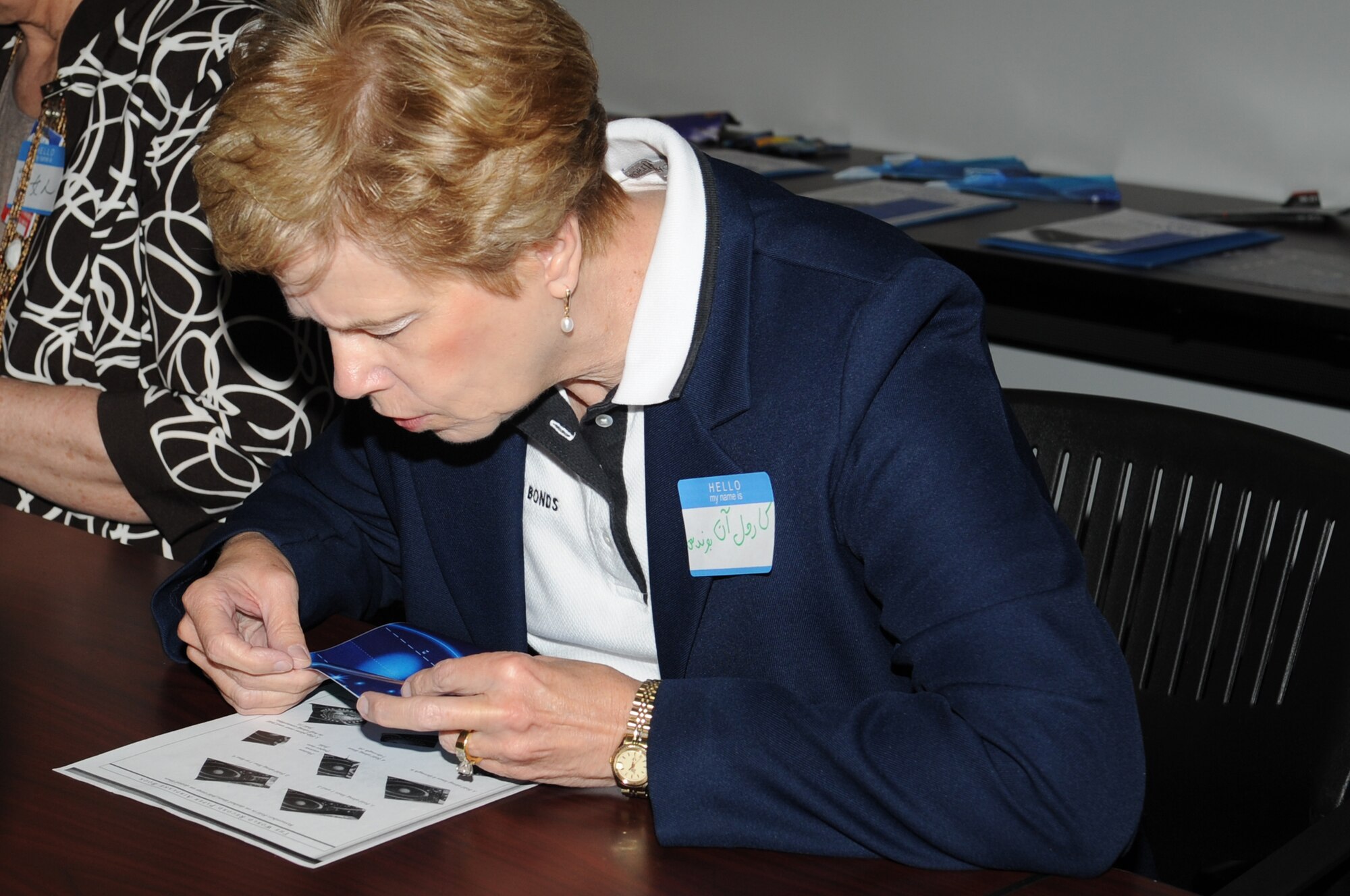 GOODFELLOW AIR FORCE BASE, Texas -- Dr. Carol Ann Bonds, San Angelo Independent School District superintendent, creates a paper airplane during the Joint Intelligence Technical Training Facility’s open house here March 29. More than 240 San Angelo community and base members attended the open house. (U.S. Air Force photo/ Staff Sgt. Laura R. McFarlane)