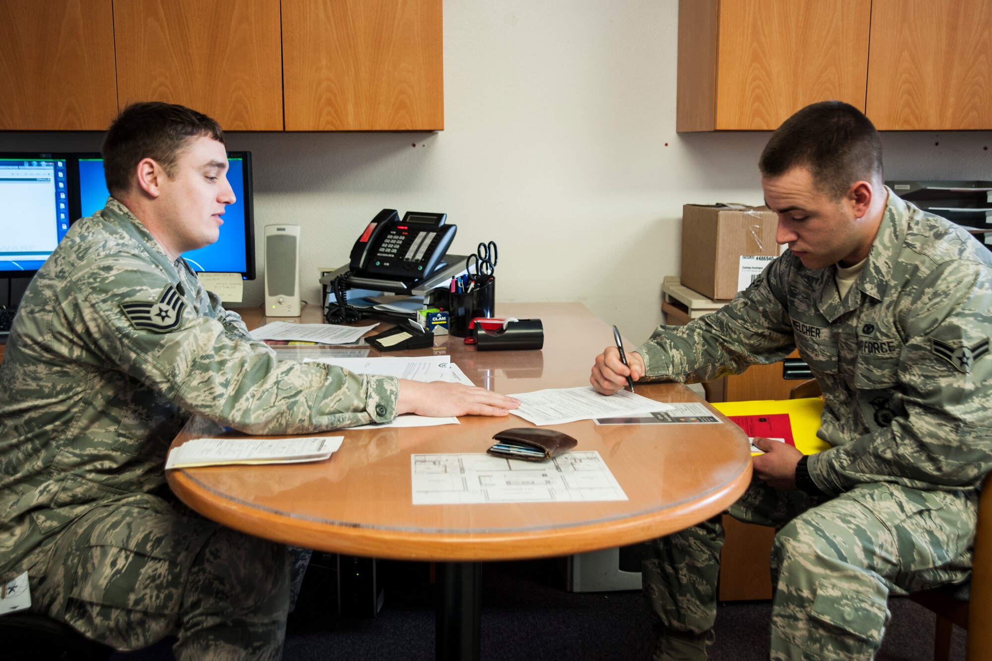 Staff Sgt. Lance Russell, 30th Civil Engineer Squadron airman dormitory leader, in-processes Airman 1st Class Chad Melcher, 30th Security Forces Squadron patrolman, April 9, 2014, Vandenberg Air Force Base, Calif. The ADLs work to maintain a good quality of life for all the dorm residents. (U.S. Air Force photo/Airman 1st Class Yvonne Morales)