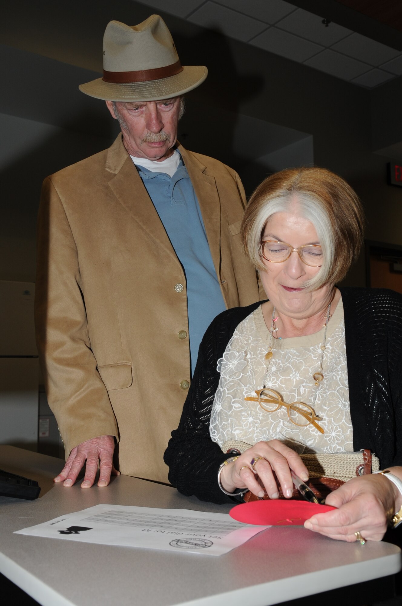 GOODFELLOW AIR FORCE BASE, Texas -- Matt and Leslie Healy, San Angelo community members, use a decoder to find the coded message during the Joint Intelligence Technical Training Facility’s open house here March 29. The decoded message welcomed moonstar junior analysts; the scenario Operation Moonstar trained visitors on capabilities students learn in the school house. (U.S. Air Force photo/ Staff Sgt. Laura R. McFarlane)