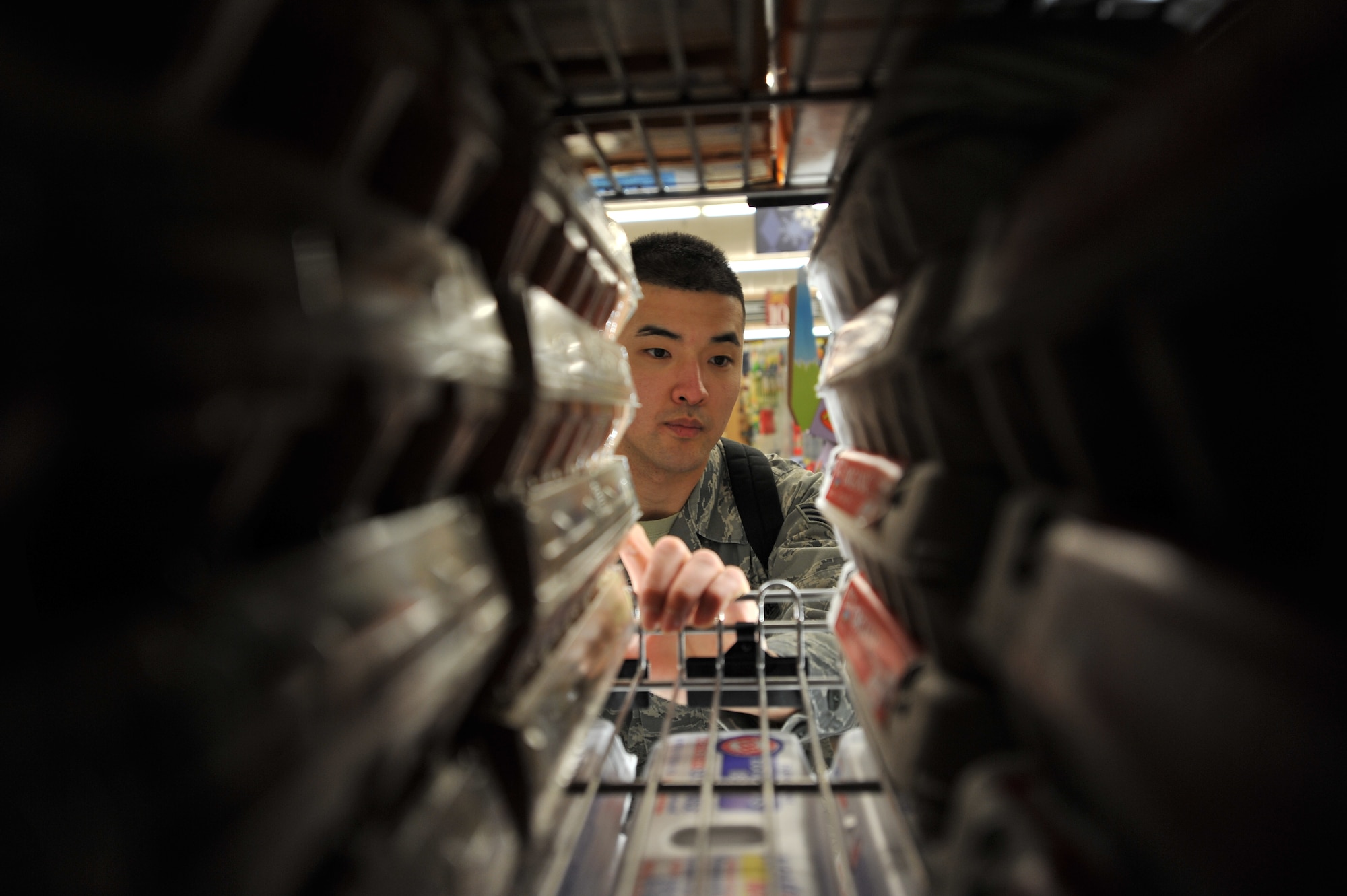 ALTUS AIR FORCE BASE, Okla. – U.S. Air Force Senior Airman Elijah Kim, 97th Medical Group public health technician, checks the expiration dates of eggs during a monthly public health inspection inside the base commissary April 9, 2014. The farm and dairy products are checked to ensure that expired or rotten products are not sold to customers. (U.S. Air Force photo by Senior Airman Dillon Davis/Released)