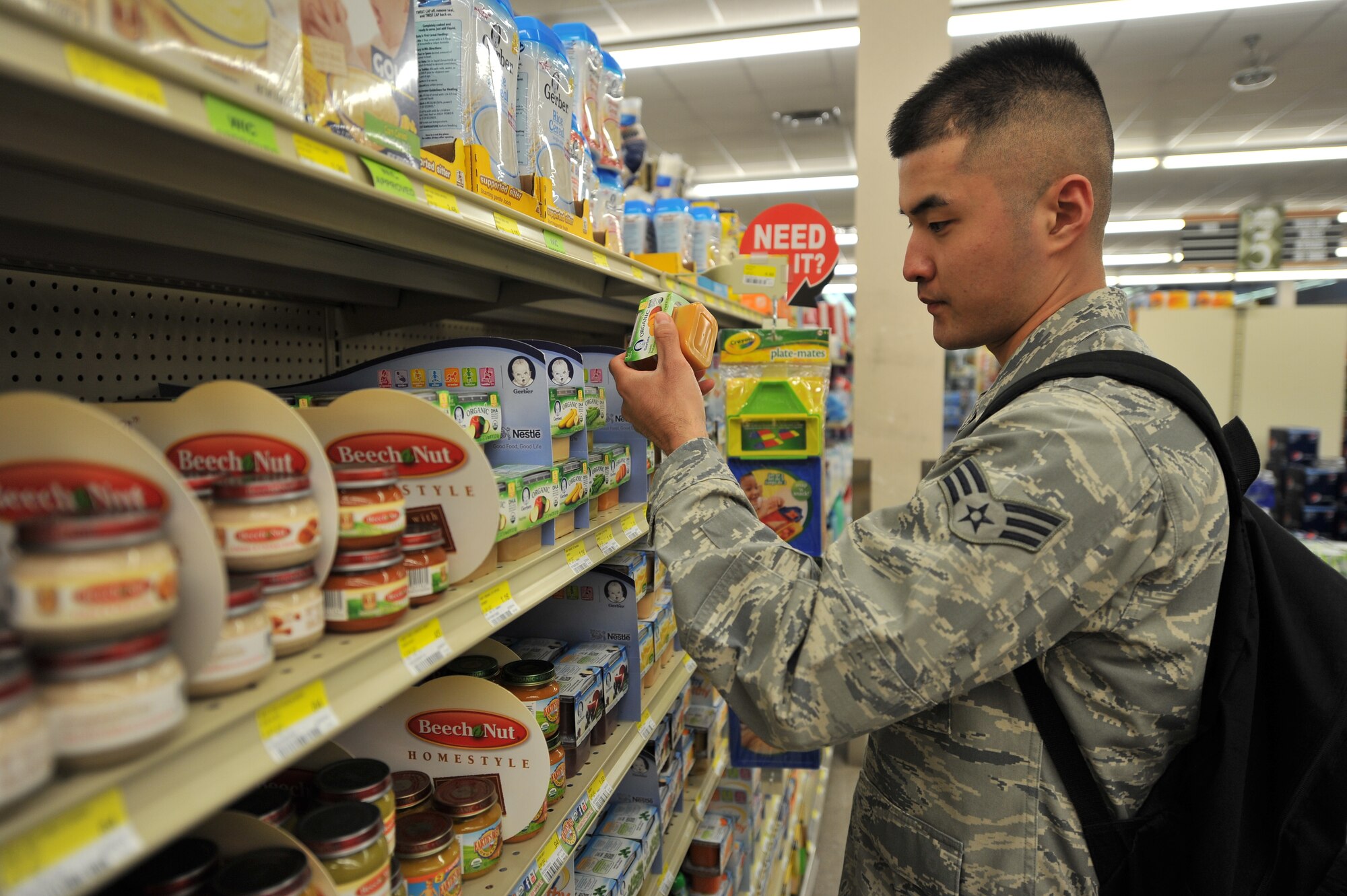 ALTUS AIR FORCE BASE, Okla. – U.S. Air Force Senior Airman Elijah Kim, 97th Medical Group public health technician, inspects a package of baby food during a monthly public health inspection inside the base commissary April 9, 2014. Baby food is inspected to ensure that it has not expired to reduce infant sickness. (U.S. Air Force photo by Senior Airman Dillon Davis/Released)