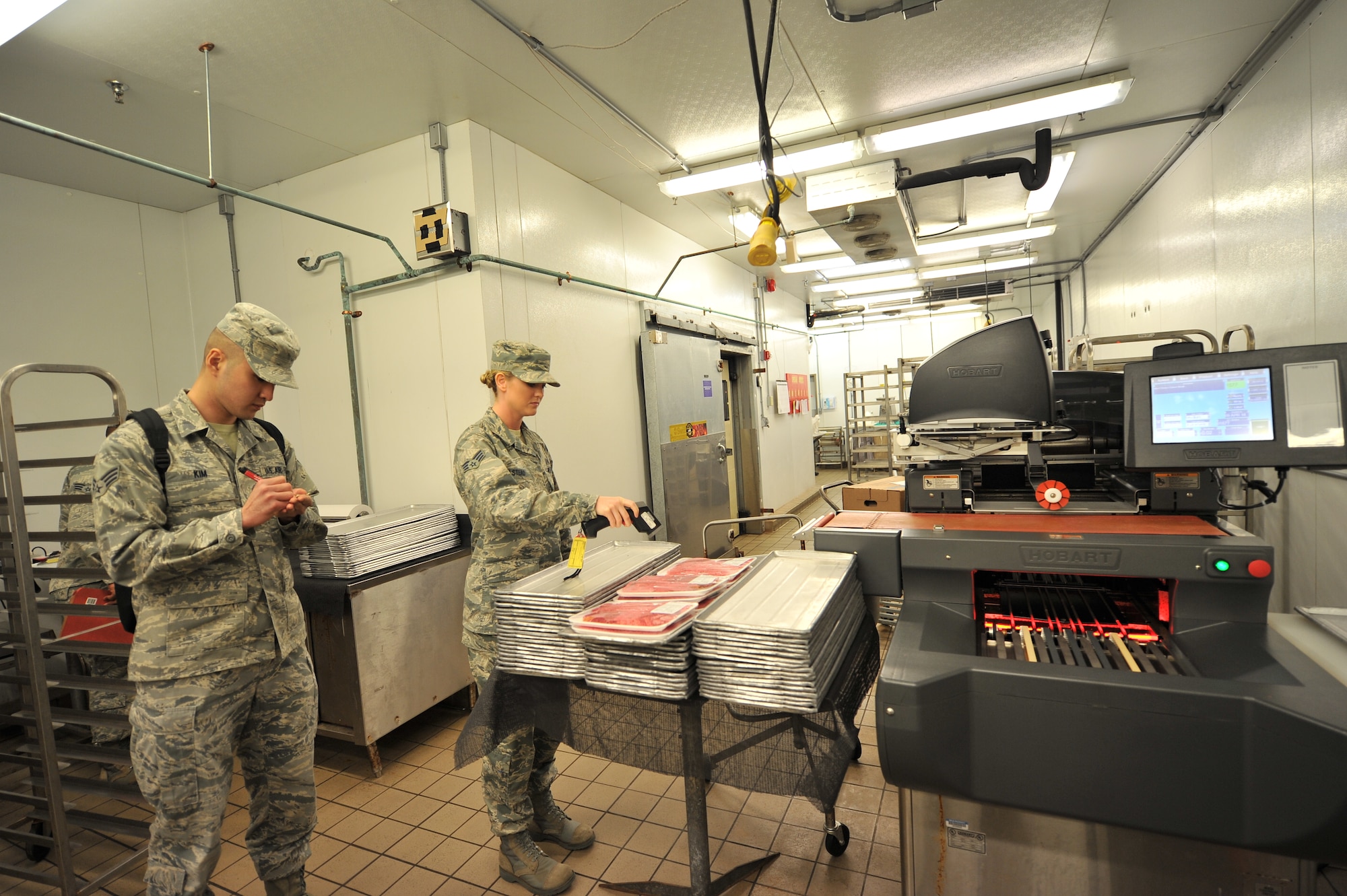 ALTUS AIR FORCE BASE, Okla. – U.S. Air Force Senior Airman Sierra Halstead, 97th Medical Group public health technician, checks the temperature of packaged beef during a monthly public health inspection inside the base commissary April 9, 2014. Packaged meat has to be properly labeled and stored at the proper temperatures to ensure that food-borne illnesses are not present. (U.S. Air Force photo by Senior Airman Dillon Davis/Released)