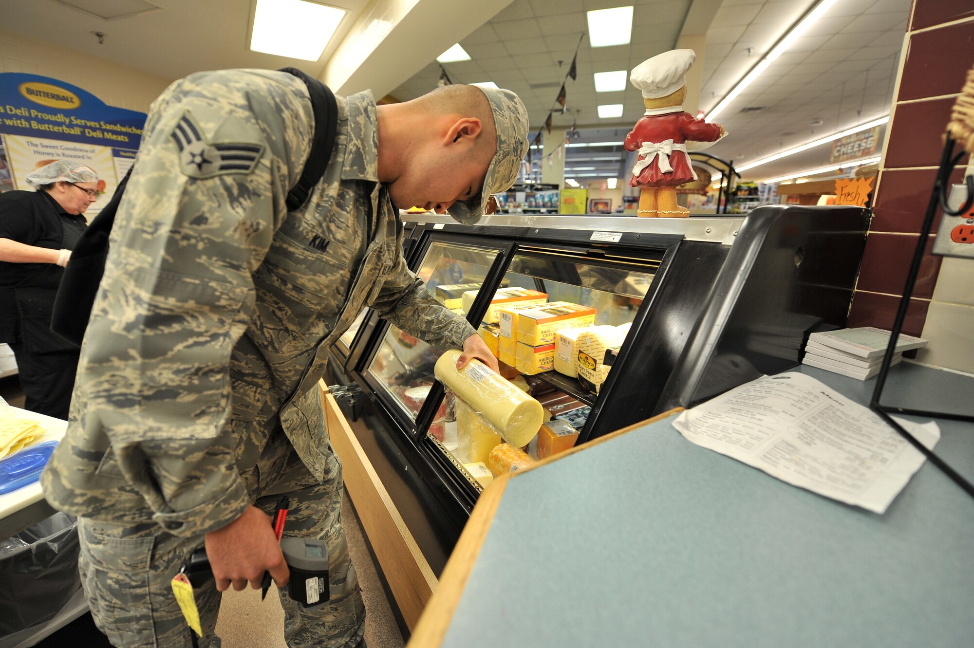 ALTUS AIR FORCE BASE, Okla. – U.S. Air Force Senior Airman Elijah Kim, 97th Medical Group public health technician, inspects a package of cheese during a monthly public health inspection inside the base commissary April 9, 2014. Kim inspected the cheese for any signs of mold as well as any packages that are expired. (U.S. Air Force photo by Senior Airman Dillon Davis/Released)