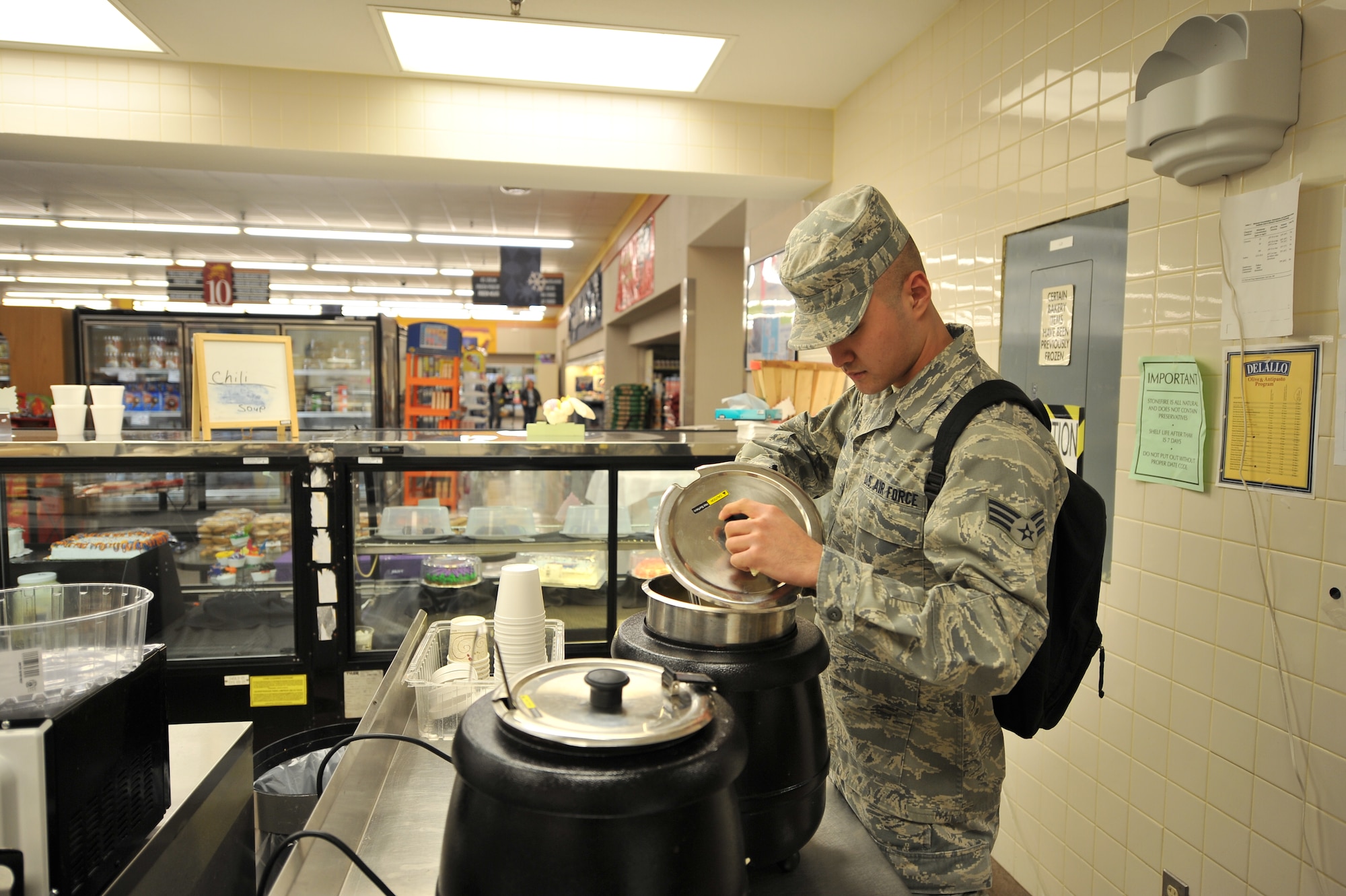 ALTUS AIR FORCE BASE, Okla. – U.S. Air Force Senior Airman Elijah Kim, 97th Medical Group public health technician, checks the temperature of soup during a monthly public health inspection inside the base commissary April 9, 2014. The inspection ensures the continuous compliance with state and federal regulations to always provide safe and edible food products. (U.S. Air Force photo by Senior Airman Dillon Davis/Released)
