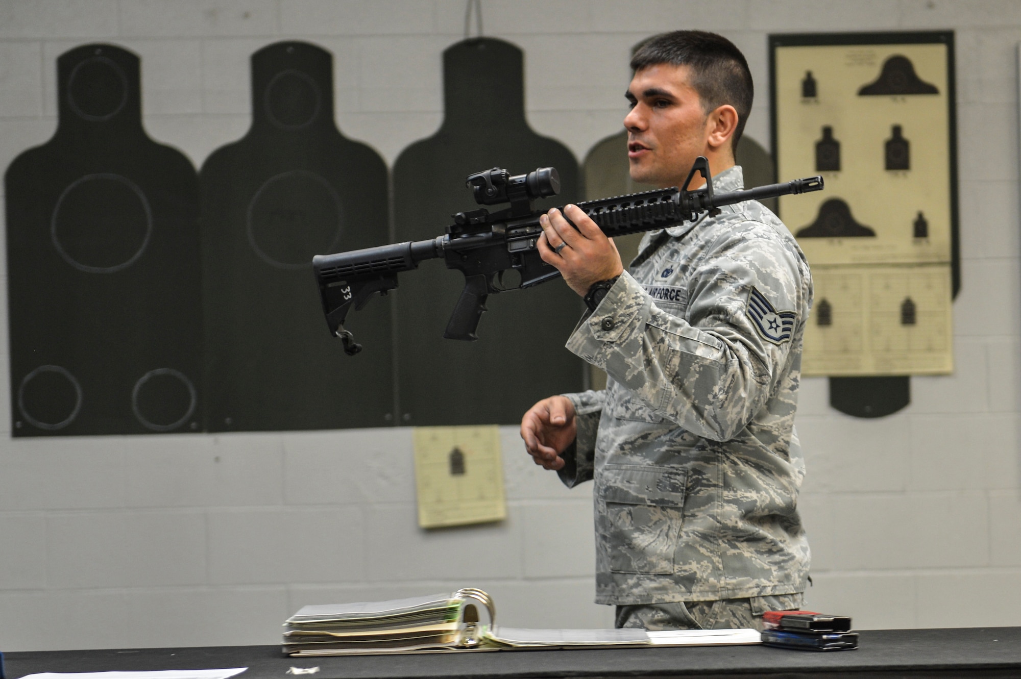 Staff Sgt. Christopher Hoffman, 627th Security Forces Squadron combat arms instructor, identifies each component of an M-4 carbine rifle to a class of McChord Airmen, April 9, 2014 at Joint Base Lewis-McChord, Wash. Enlisted combat arms instructors are certified security forces members who have completed the Combat Arms Apprentice Course at Joint Base San Antonio, Texas and serve as the professionals of small arms training within the Air Force. (U.S. Air Force photo/Staff Sgt. Russ Jackson)