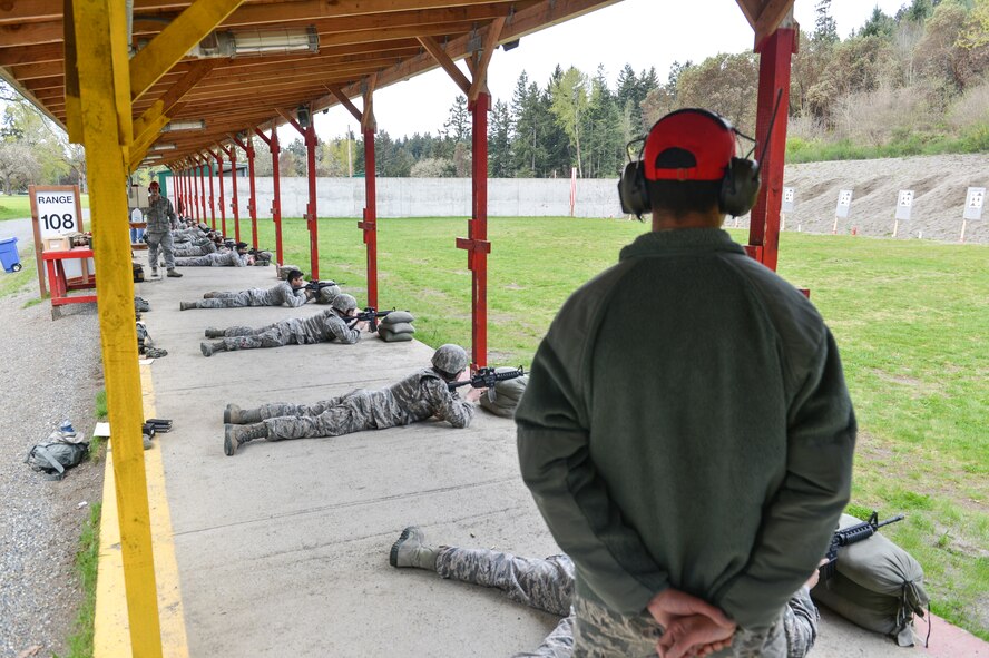 Tech. Sgt. David Buchanan, 446 Security Forces Squadron combat arms instructor, observes McChord Field Airmen to ensure the firing line is safe at all times at Range 108 next to North Fort Lewis, April 9, 2014 at Joint Base Lewis-McChord, Wash. The red hat instructors wear is specifically for the firing range in order to easily distinguish them. As a result, combat arms instructors have acquired the nickname, “Red Hats.” (U.S. Air Force photo/ Staff Sgt. Russ Jackson) 