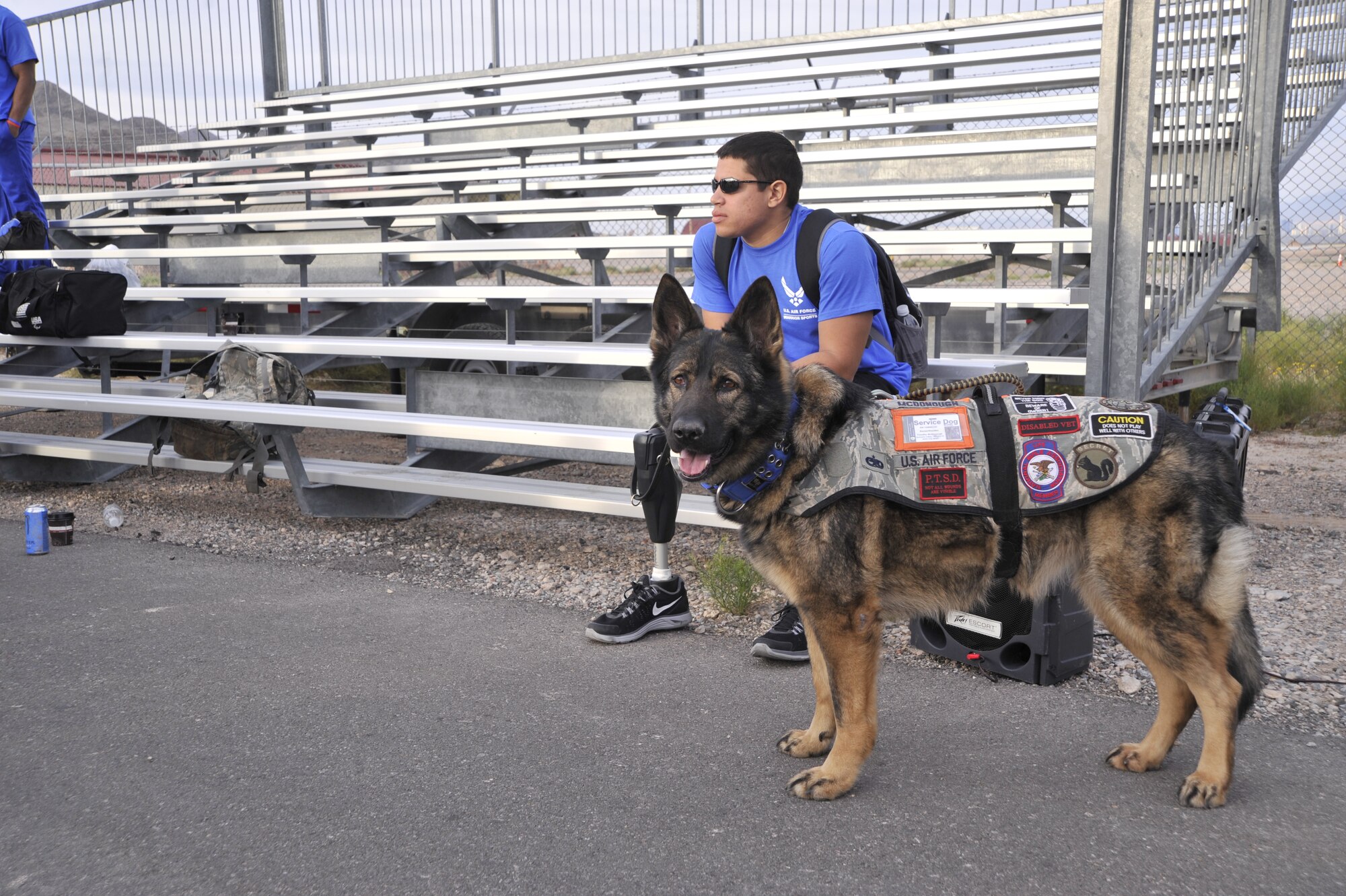 Staff Sgt. Mark Johnson and service dog Bailey wait for the start of the cycling competition during the 2014 Wounded Warrior Air Force Trials at Nellis Air Force Base, Las Vegas, Nev., April 9, 2014. Active duty and retired Airmen competed in swimming, basketball, volleyball, track and filed events, archery and shooting competitions.(U.S. Air Force photo by Airman 1st Class Christian Clausen)