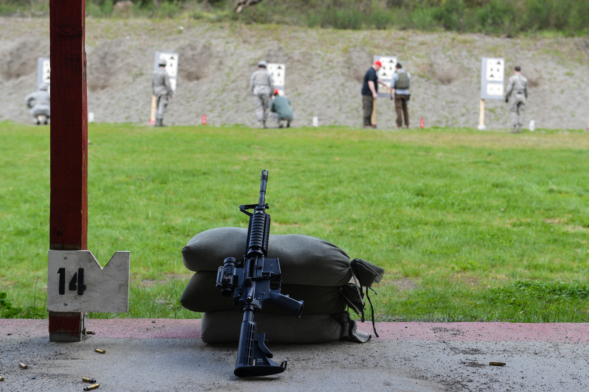 Combat arms instructors review zeroing corrections with McChord Field Airmen individually before they can qualify on the M-4 carbine rifle at Range 108 next to North Fort Lewis, April 9, 2014 at Joint Base Lewis-McChord, Wash. While most of their time is concentrated on the firing range, combat arms instructors inspect and repair weapons, schedule classes, and manage munitions accounts, spare parts and hazardous material issues. (U.S. Air Force photo/ Staff Sgt. Russ Jackson)