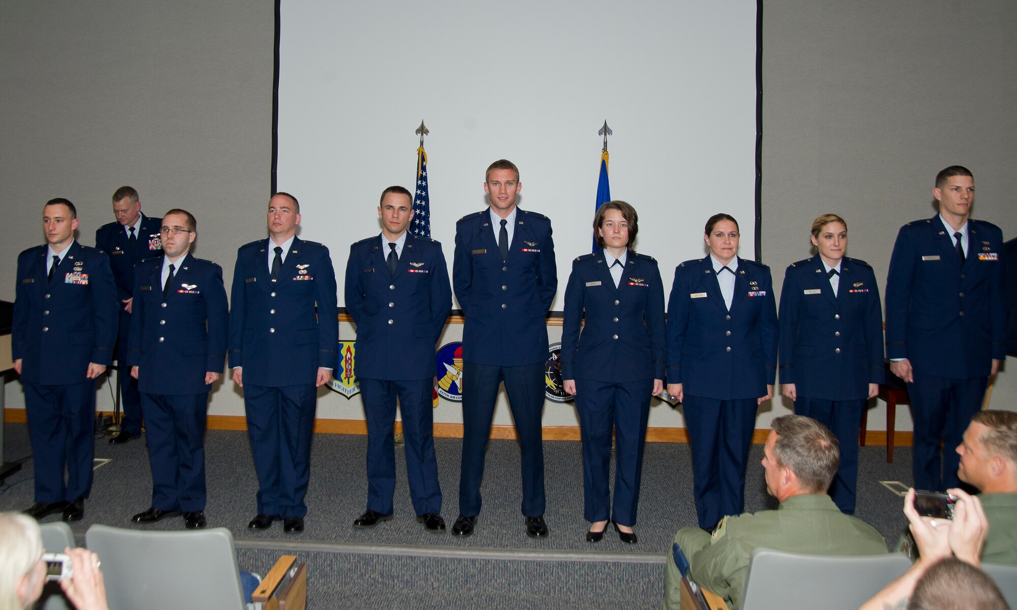 Nine Team Tyndall Airmen stand at attention after graduating from the Undergraduate Air Battle Manager training program in a ceremony April 9. (U.S. Air Force photo by Airman 1st Class Alex Echols)