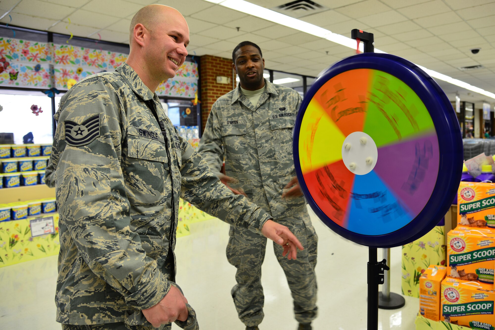 U.S. Air Force Tech. Sgt. Uri Swingle, 1st Maintenance Squadron precision guided munitions supervisor, spins a Sexual Assault Awareness Month prize wheel as Tech. Sgt. Warren O’Brien, Joint Base Langley-Eustis Victim Advocate, watches during a Meet your Victim Advocate event at Langley Air Force Base, Va. April 8, 2014. Participants had to spin the wheel and answer a sexual assault prevention-related question to win a prize. Swingle is a native of Stevensville, Mich., and O’Brien hails from San Antonio, Texas. (U.S. Air Force photo by Senior Airman Aubrey White/Released)