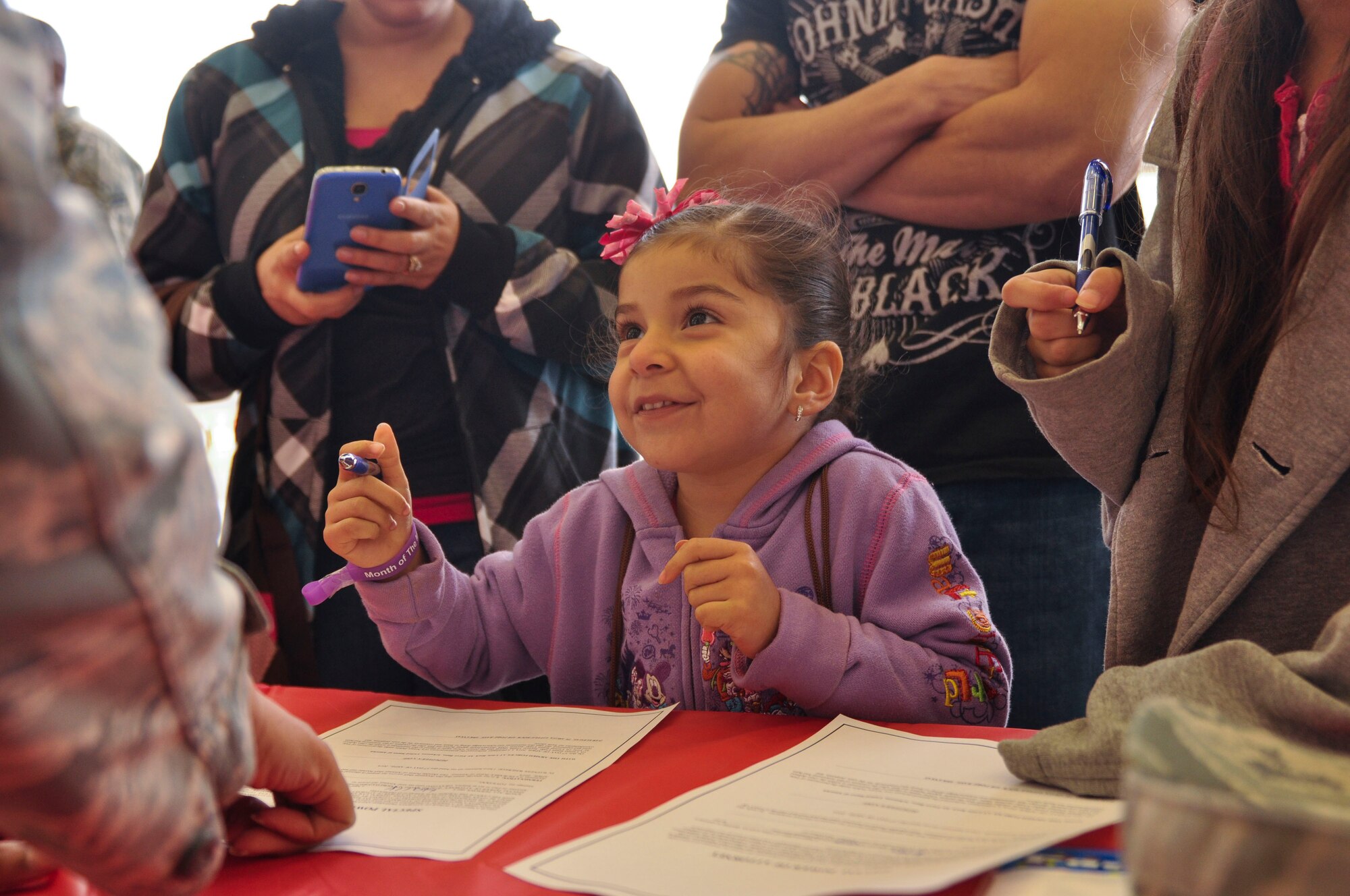 Haily, 4, prepares to sign her special power of attorney form April 5 during the Kids Understanding Deployment Operations event at Little Rock Air Force Base, Ark. Special forms were created for the children; they signed for a family member to care for their dogs and toys. (U.S. Air Force photo by Senior Airman Regina Agoha)