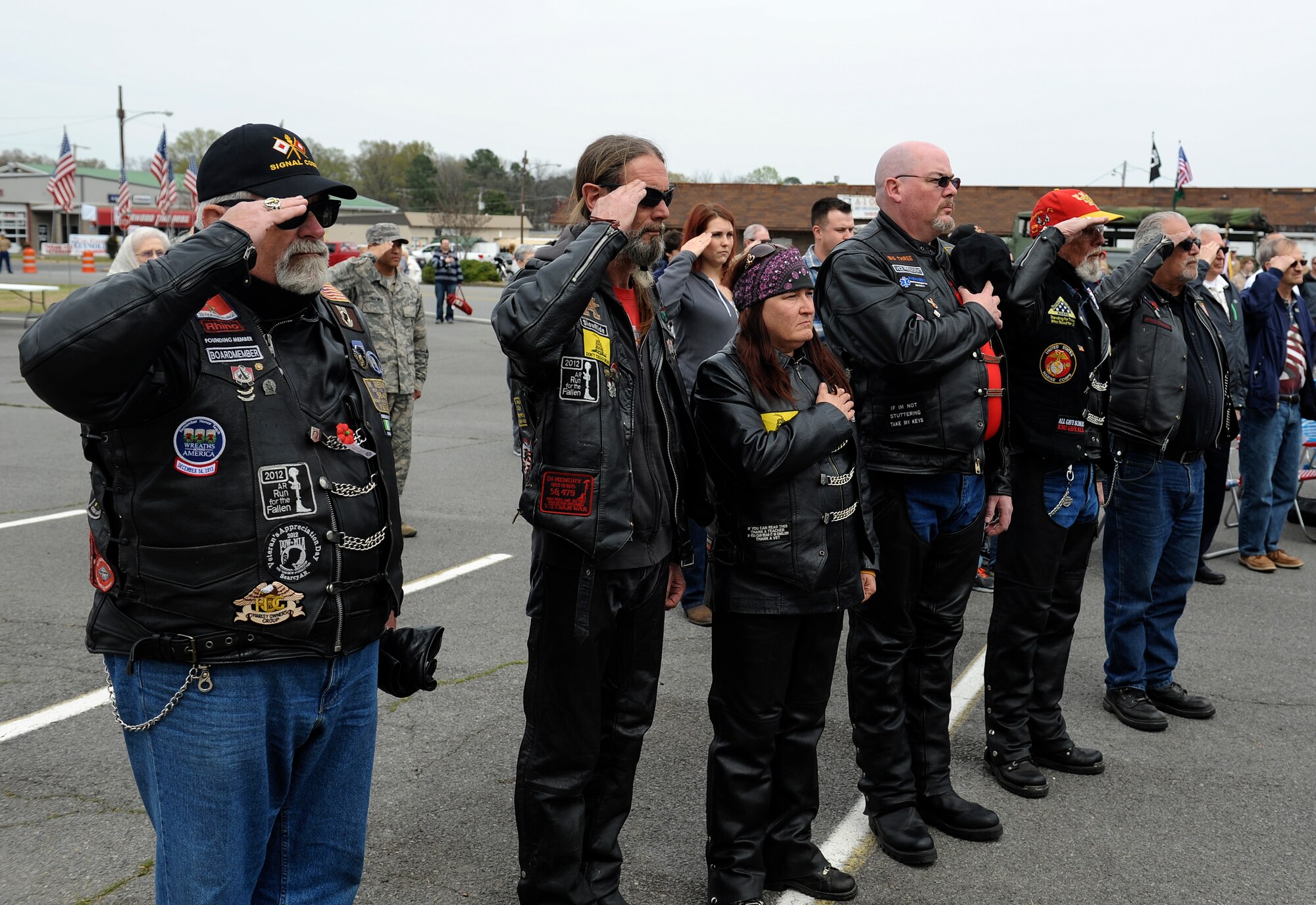 Vietnam veterans pay tribute during the playing of the national anthem during the Welcome Home Vietnam Veterans Day event April 5, 2014, in Jacksonville, Ark. The event provided recognition for Vietnam veterans and included a parade in honor of their service. (U.S. Air Force photo by Staff Sgt. Jessica Condit)