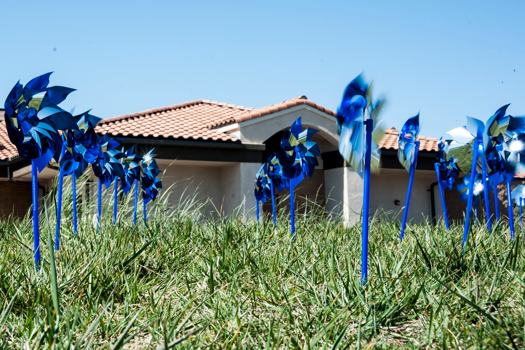 Pinwheels turn as the wind blows outside the Child Development Center, April 7, 2014, Vandenberg Air Force Base, Calif. More than 450 pinwheels were distributed to base agencies in April in recognition of Child Abuse Prevention Month. (U.S. Air Force photo/Airmen 1st Class Yvonne Morales) 