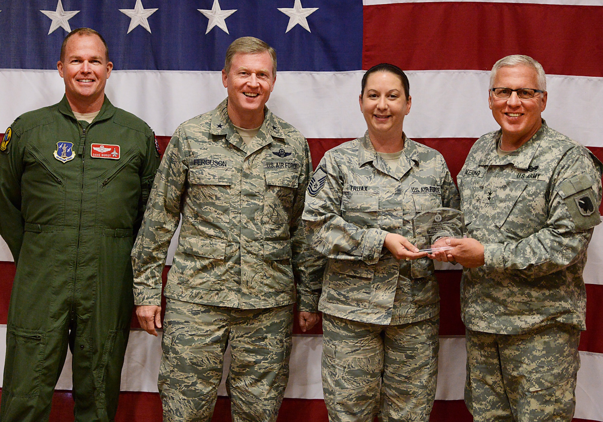 Oklahoma Adjutant General, Major General Myles Deering, along with Assistant Adjutant General Air, Brigadier General Gregory Ferguson and 138th Fighter Wing Commander, Colonel David Burgy, present Master Sergeant Allie Truax with the Recruiting Supervisor of the Year award during a ceremony at the 138th Fighter Wing, Tulsa Air National Guard, April 6, 2014.  The luncheon and award ceremony was held to honor the 2013 Outstanding Airman of the Year for the 138th FW.   (U.S. National Guard photo by Master Sgt.  Mark A. Moore/Released)