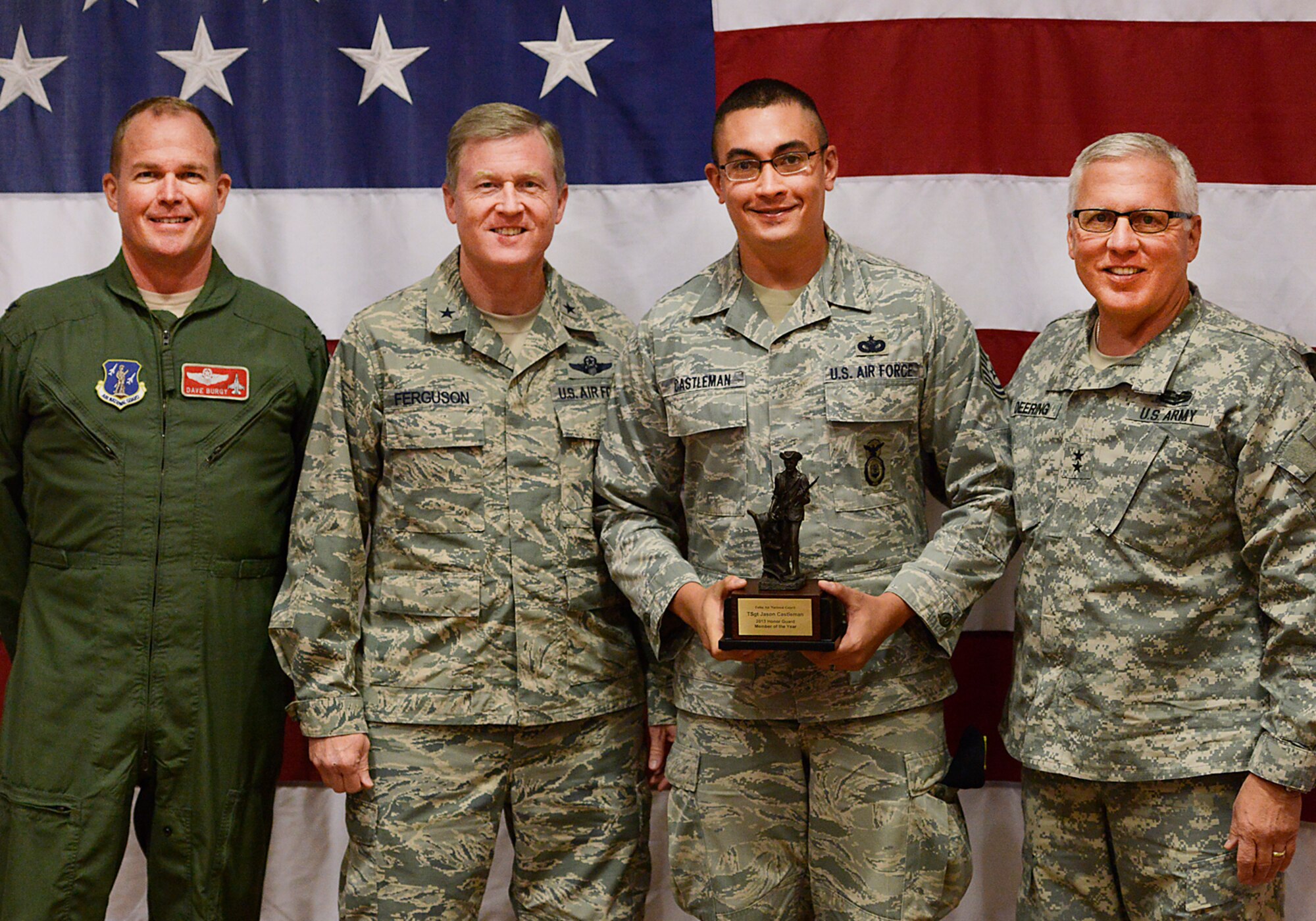 Oklahoma Adjutant General, Major General Myles Deering, along with Assistant Adjutant General Air, Brigadier General Gregory Ferguson and 138th Fighter Wing Commander, Colonel David Burgy, present Technical Sergeant Jason Castleman with the Honor Guard Member of the Year award during a ceremony at the 138th Fighter Wing, Tulsa Air National Guard, April 6, 2014.  The luncheon and award ceremony was held to honor the 2013 Outstanding Airman of the Year for the 138th FW.   (U.S. National Guard photo by Master Sgt.  Mark A. Moore/Released)