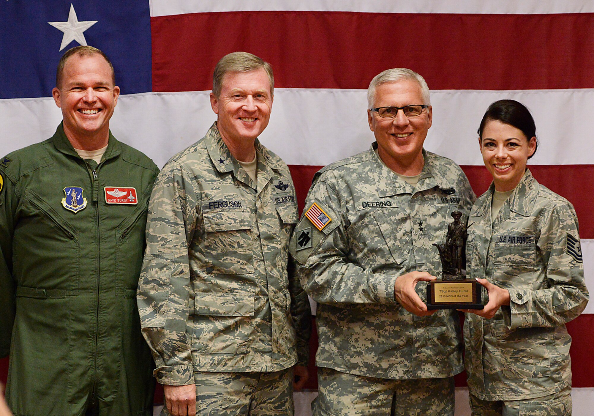 Oklahoma Adjutant General, Major General Myles Deering, along with Assistant Adjutant General Air, Brigadier General Gregory Ferguson and 138th Fighter Wing Commander, Colonel David Burgy, present Technical Sergeant Kalley Hurst with the Non-Commissioned Officer of the Year award during a ceremony at the 138th Fighter Wing, Tulsa Air National Guard, April 6, 2014.  The luncheon and award ceremony was held to honor the 2013 Outstanding Airman of the Year for the 138th FW.   (U.S. National Guard photo by Master Sgt.  Mark A. Moore/Released)