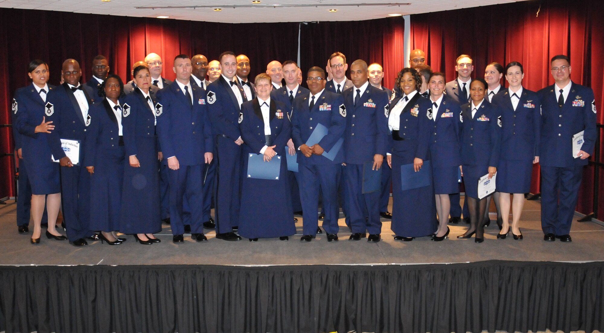 Thirty-two reservists from the 512th Airlift Wing stand together on stage moments after being inducted as senior noncommissioned officers during a ceremony April 5, 2014, at the Delaware Technical Community College Conference Center, Dover, Del. The total number of inductees is 38, but six of them were unable to attend the annual event. (U.S. Air Force photo/Senior Airman Joe Yanik)