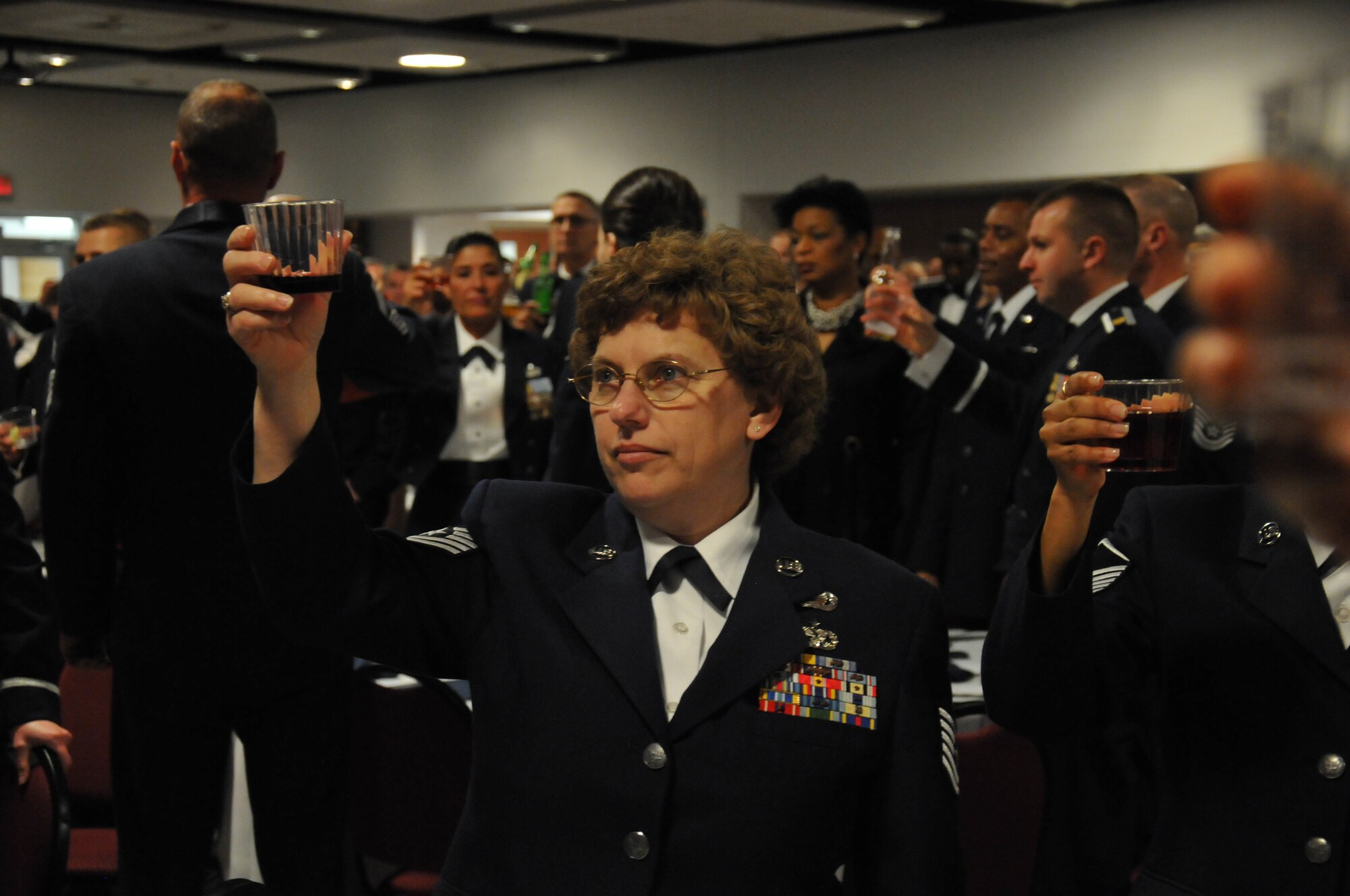 Tech. Sgt. Melena Quetel, 46th Aerial Port Squadron, 512th Airlift Wing, raises a glass to toast current American prisoners of war and military members currently missing in action during the Liberty Wing's senior noncommissioned officer induction ceremony April 5, 2014, at the Delaware Technical Community College Conference Center, Dover, Del. As of 2014, at least one American military member became a POW and at least three are MIA during the Global War on Terrorism. (U.S. Air Force photo/Senior Airman Joe Yanik)