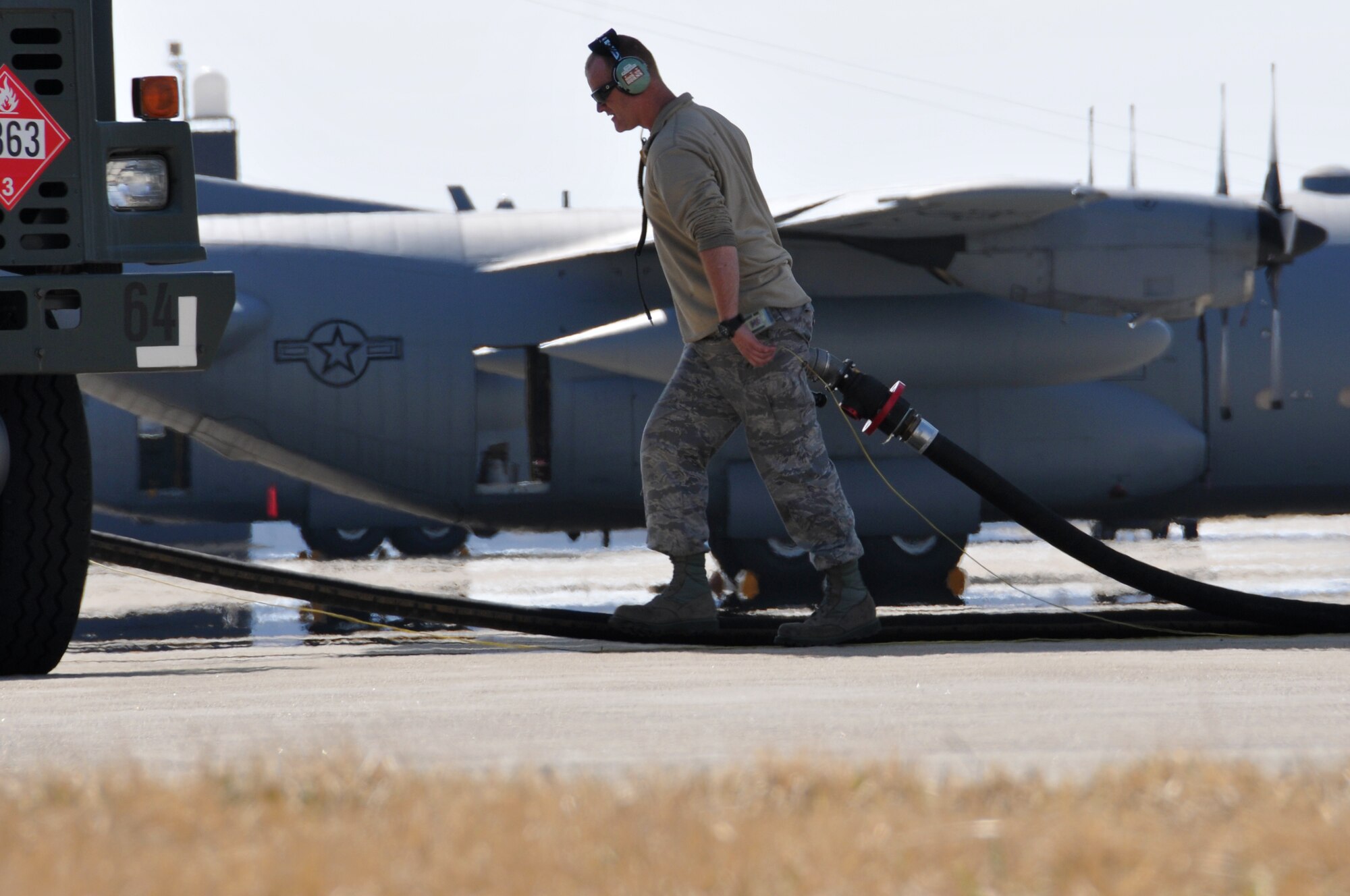 164th Airlift Squadron flight crew members wait to board a C-130H Hercules as it taxis in from another crews flight, April 2, 2014, Mansfield, OH.The 179th Airlift Wing expects to have a total of 8 C-130H Hercules.(U.S. Air National Guard Photo by TSgt Joseph Harwood \Released)