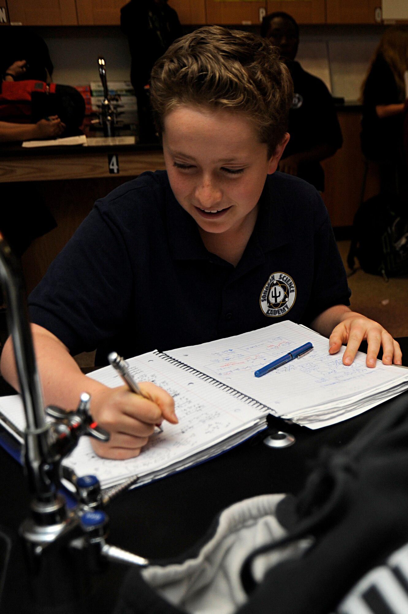 David Zulli, son of U.S. Air Force Lt. Col. Daniel Zulli, 355th Fighter Wing base chaplain, completes schoolwork during a class at Davis-Monthan Air Force Base, Ariz., April 4, 2014. David is involved in many community organizations and has gained 130 volunteer hours since August 2013. (U.S. Air Force photo by Airman 1st Class Betty R. Chevalier/released)