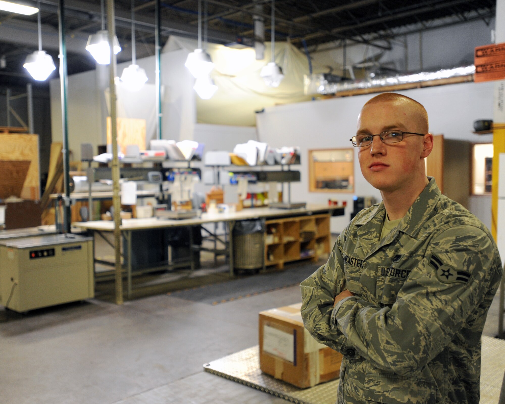 Airman 1st Class Carter Lancaster, 319th Logistics Readiness Squadron traffic management apprentice, stands in front of the packaging table in the LRS packaging warehouse on Grand Forks Air Force Base, N.D., April 3, 2014. Lancaster was named warrior of the week for the first week of April. (U.S. Air Force photo/Senior Airman Zachiah Roberson)
