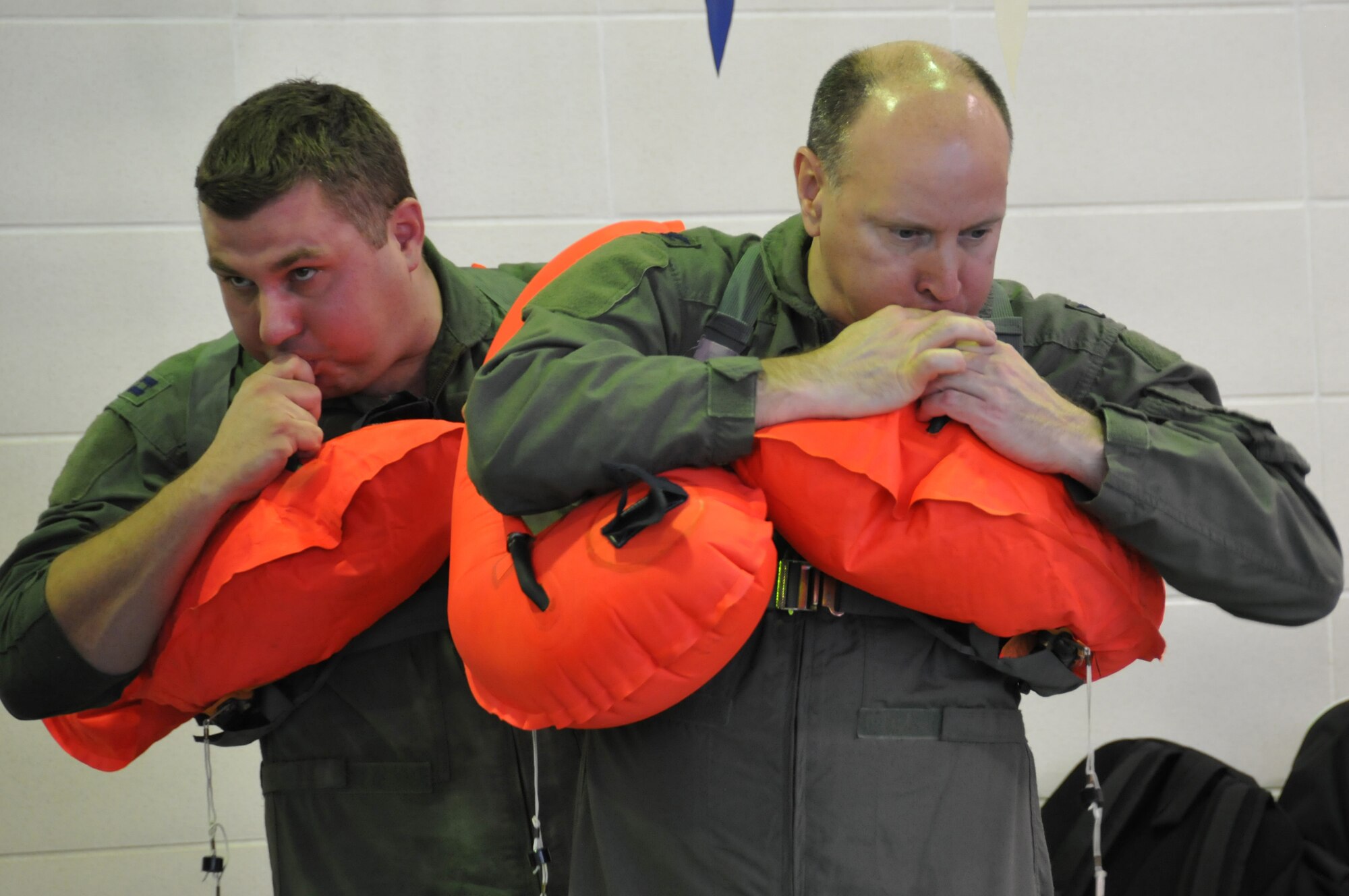Members of the 164th Airlift Squadron perform water survival training at the Galion YMCA, April 6, 2014, Galion, OH. The C130 Hercules aircrew members are required to stay current in survival tactics and procedures on both land and water. (U.S. Air National Guard Photo by TSgt Joseph Harwood \Released)