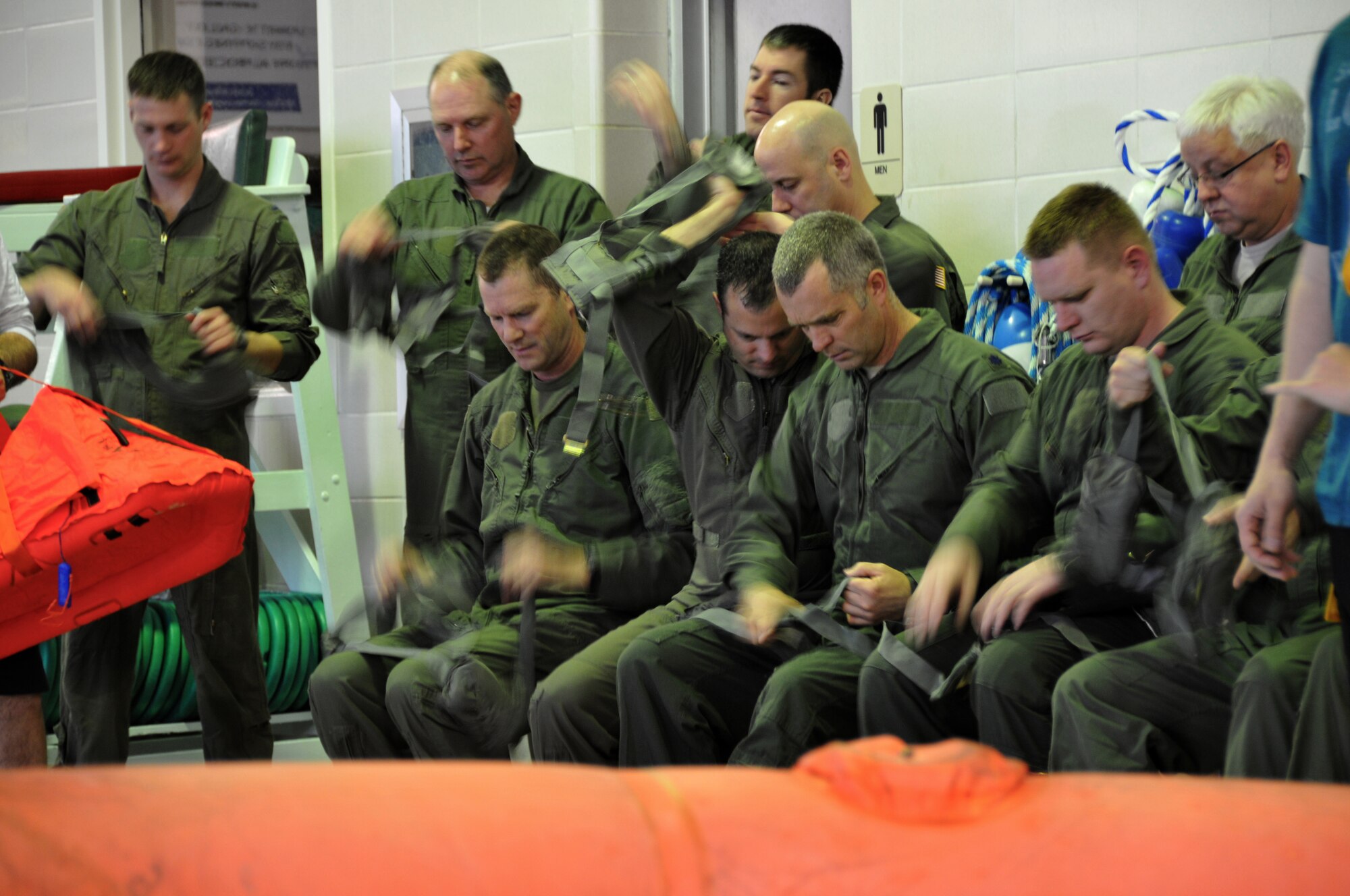 Members of the 164th Airlift Squadron perform water survival training at the Galion YMCA, April 6, 2014, Galion, OH. The C130 Hercules aircrew members are required to stay current in survival tactics and procedures on both land and water. (U.S. Air National Guard Photo by TSgt Joseph Harwood \Released)