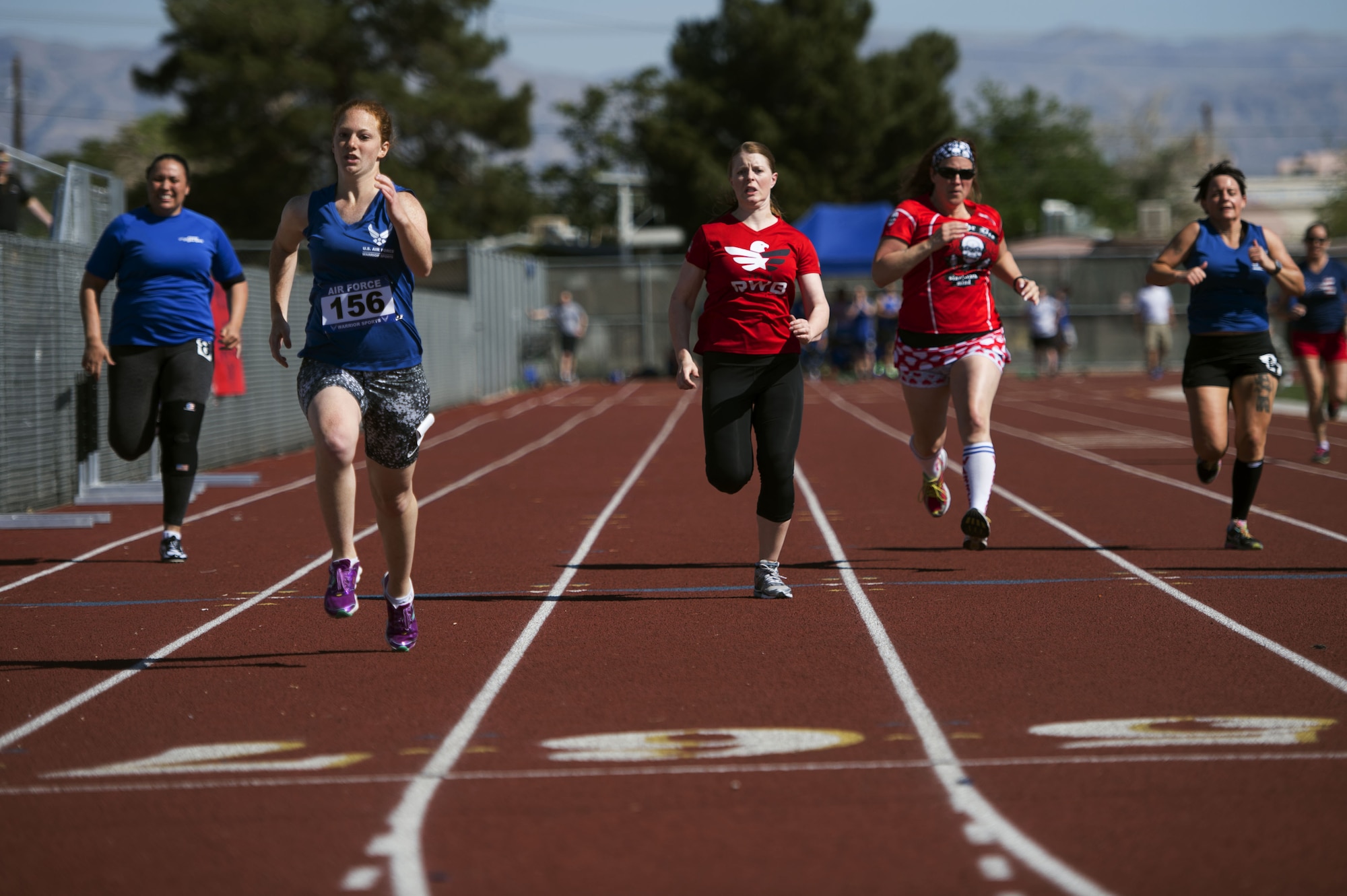 Airmen race to the finish line during the track and field portion of the Air Force Trials on April 8, 2014, at Rancho High School in Las Vegas, Nev. The Air Force Trials give injured, ill and wounded Airmen a chance to compete in Paralympic-style events. (U.S. Air Force photo/Senior Airman Jette Carr)


