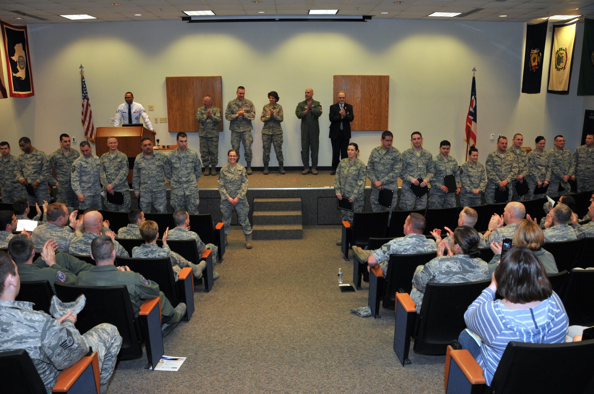 Members of the 179th Airlift Wing gather to celebrate the accomplishments of 21 fellow airmen who are receiving Community College of the Air Force degrees, April 5, 2014, Mansfield, OH. Guest speaker, Dr. Dory Dieb, Ph.D., President of North Central State College, presents the graduates with their diploma and speaks of the importance of further education. (U.S. Air National Guard Photo by TSgt Joseph Harwood \Released)
