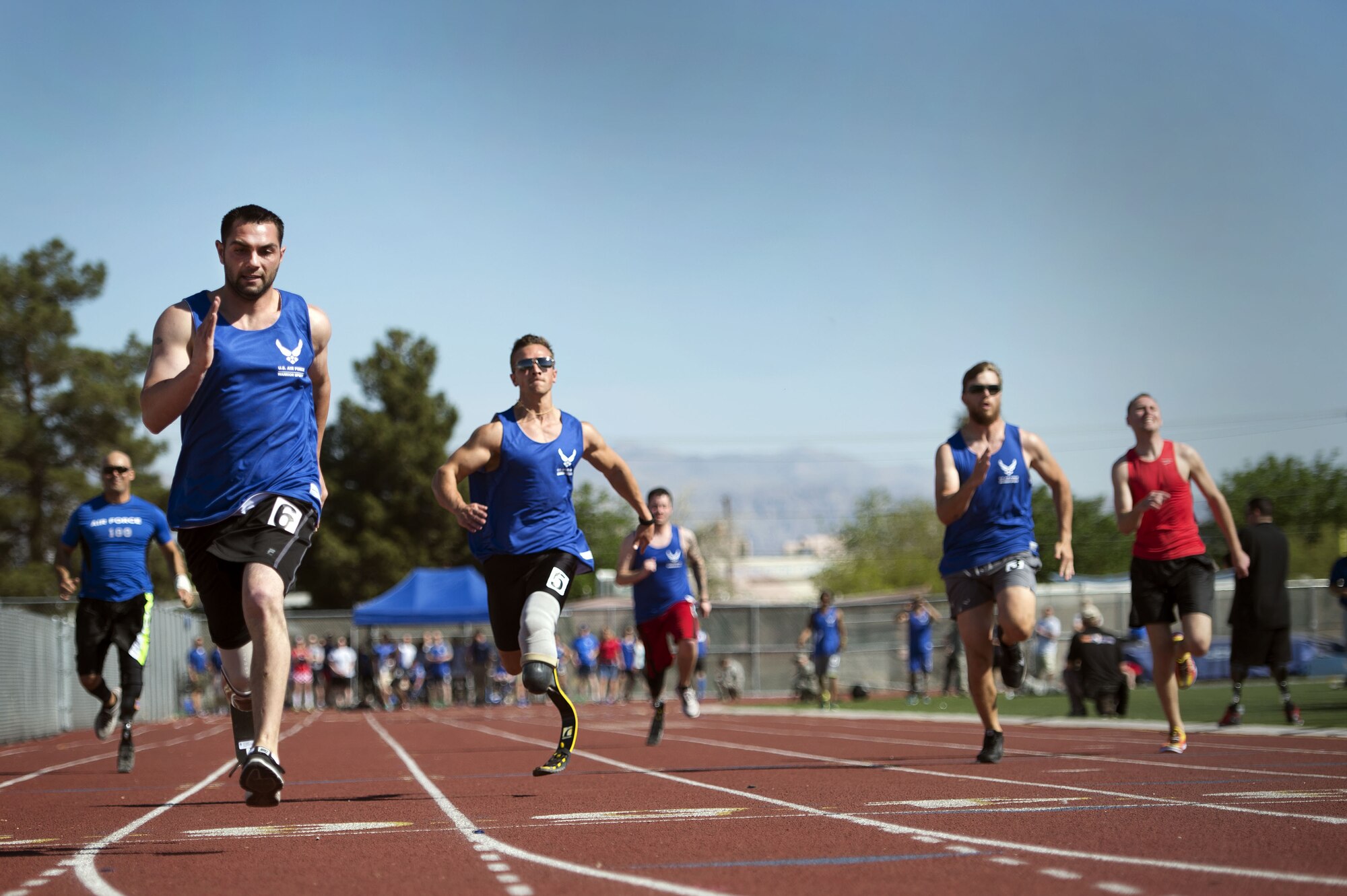 Airmen race to the finish line during the track and field portion of the Air Force Trials on April 8, 2014, at Rancho High School in Las Vegas, Nev. The Air Force Trials give injured, ill and wounded Airmen a chance to compete in Paralympic-style events. (U.S. Air Force photo/Senior Airman Jette Carr)