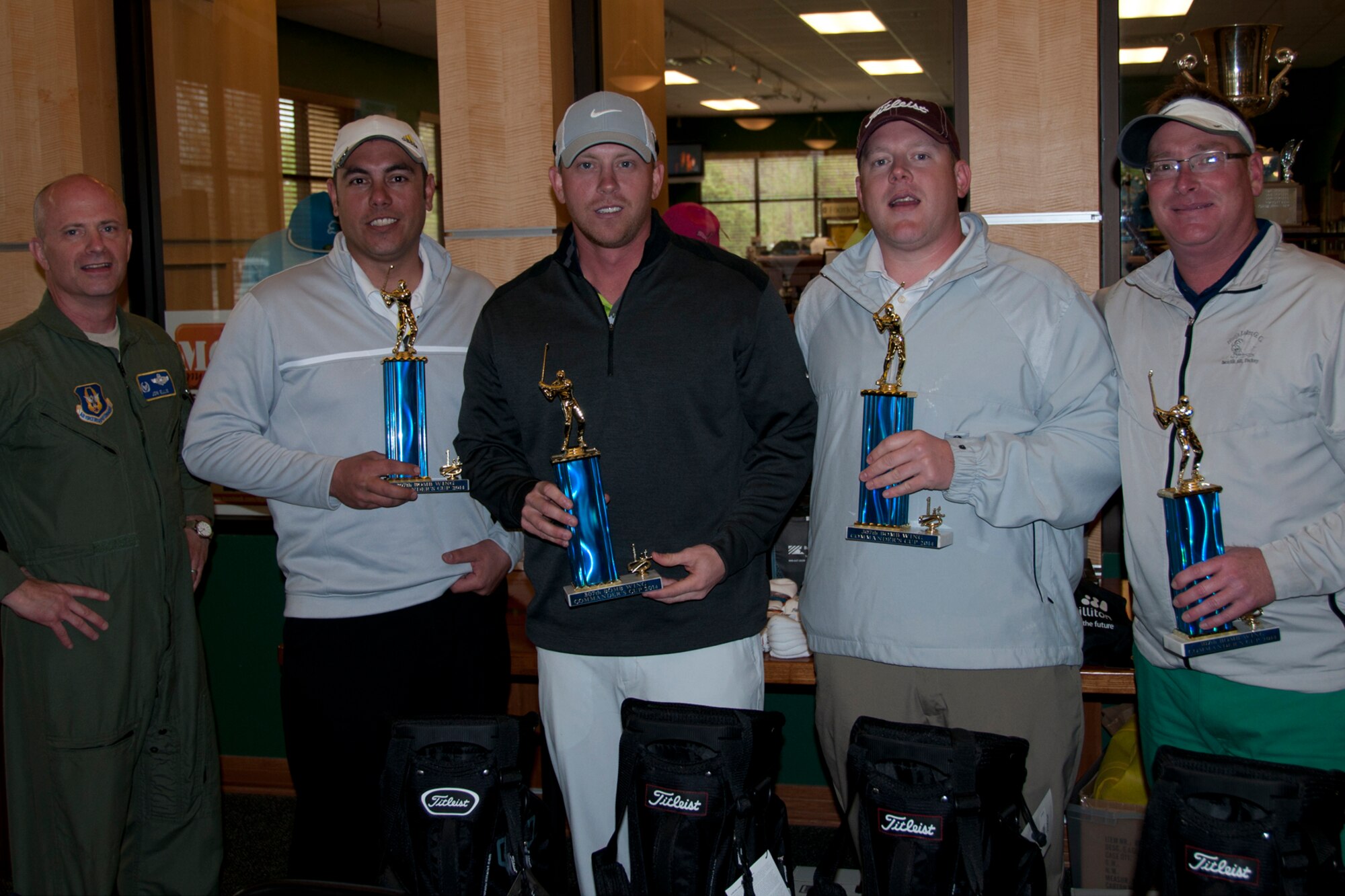 Col. Jonathan Ellis, 307th Bomb Wing commander, presents trophies to the winners of the 307th Bomb Wing Commander's Cup golf tournament at Barksdale Air Force Base, La., April 5, 2014.  The winning team of Jonathon Wilson, Will Rhodes, Stephen Curley and Joshua Wendt battled windy, cool conditions to shoot 14 under par and garner first place.  (U.S. Air Force photo by Tech. Sgt. Ted Daigle/Released)