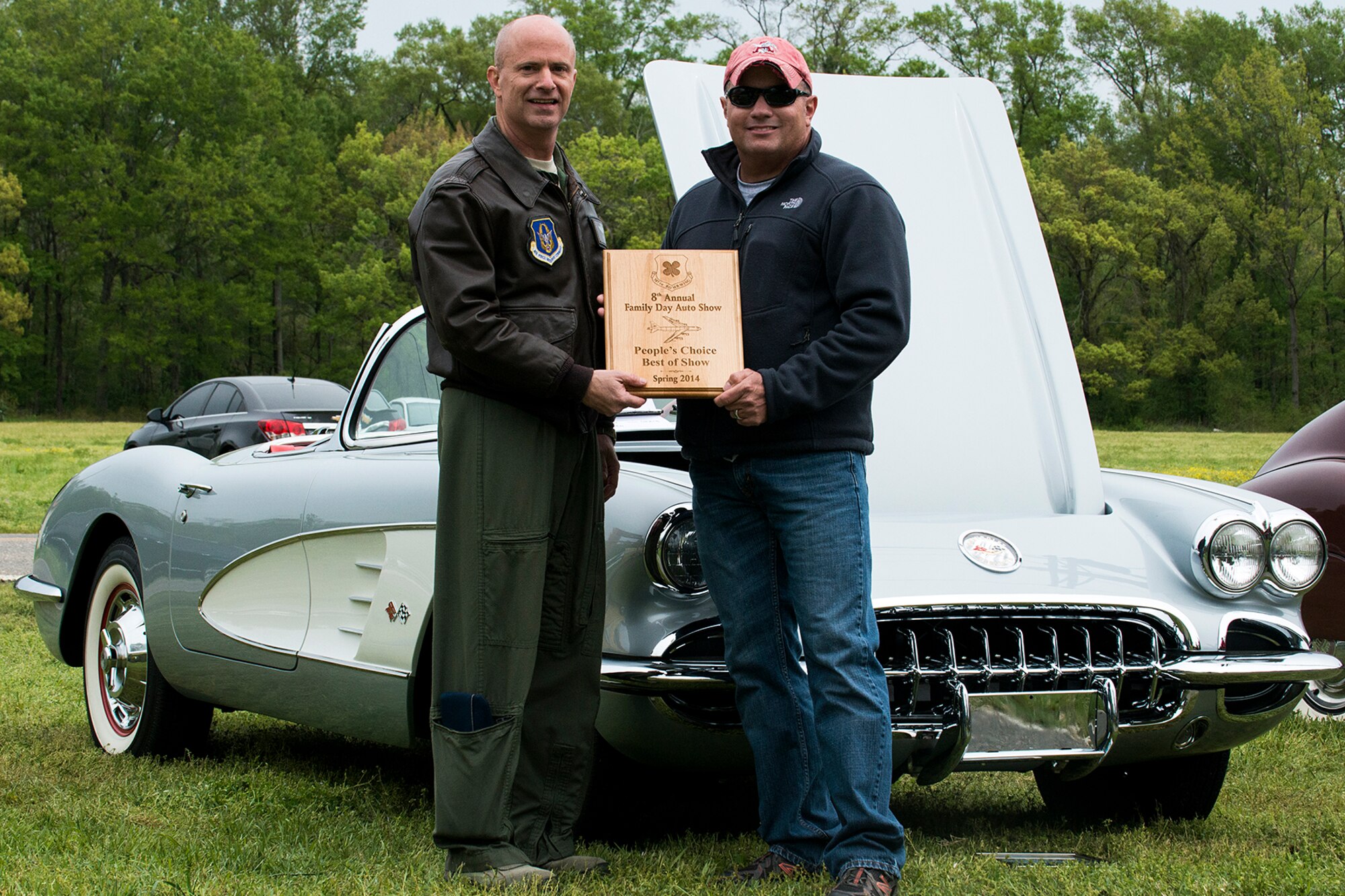 U.S. Air Force Col. Jonathan Ellis, 307th Bomb Wing commander, presents a People's Choice award to Senior Master Sgt. Pete Cohen during Family Day, April 5, 2014, Barksdale Air Force Base, La. Winners of the Car Show are decided by votes submitted by attendees of Family Day. (U.S. Air Force photo by Master Sgt. Greg Steele/Released)