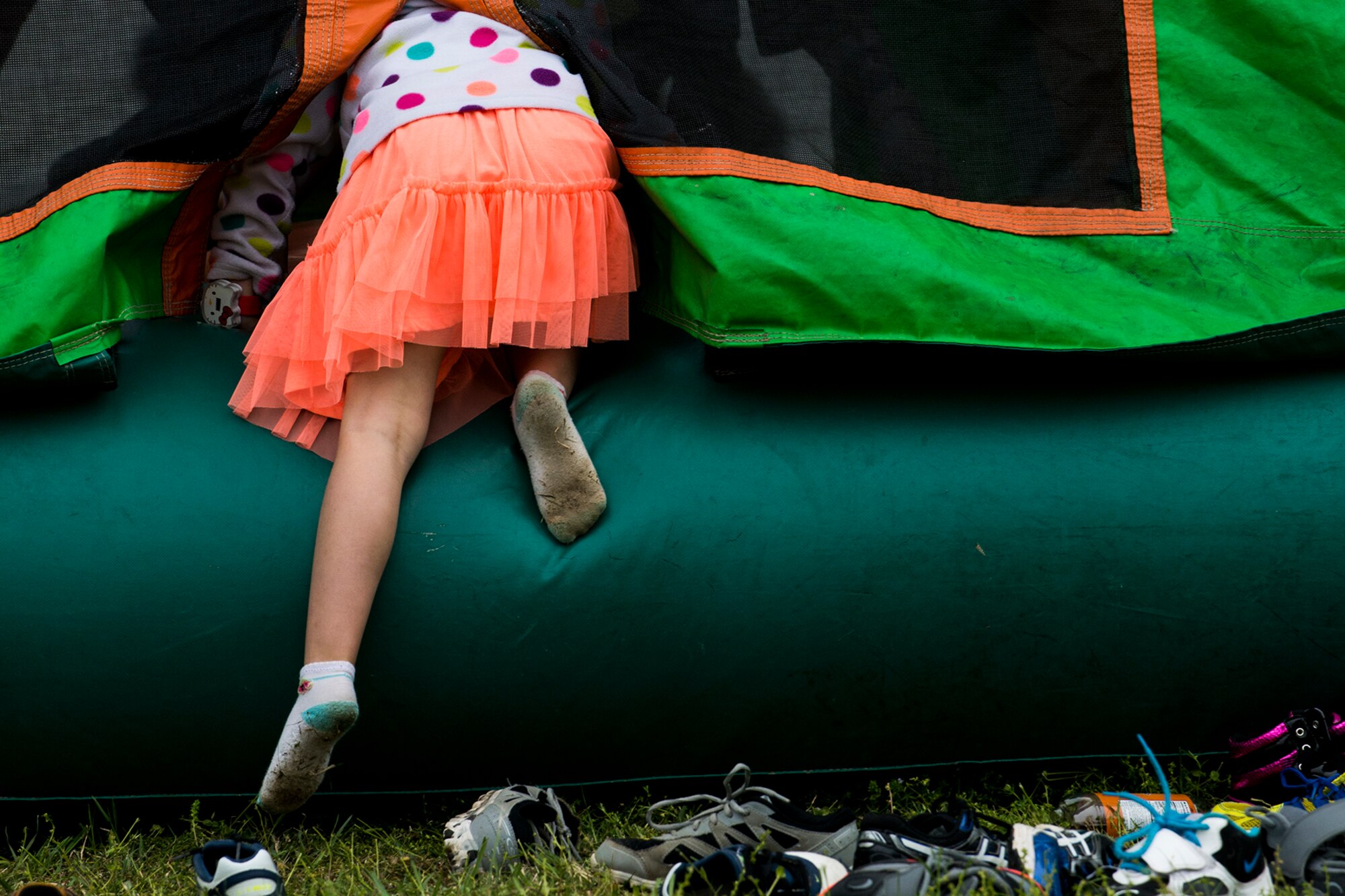 A girl climbs into a jumping house during the 307th Bomb Wing Family Day, April 5, 2014, Barksdale Air Force Base, La. Family Day is an annual event giving Airmen an opportunity to bring their families with them during a Unit Training Assembly to take time out for fun and camaraderie. (U.S. Air Force photo by Master Sgt. Greg Steele/Released)
