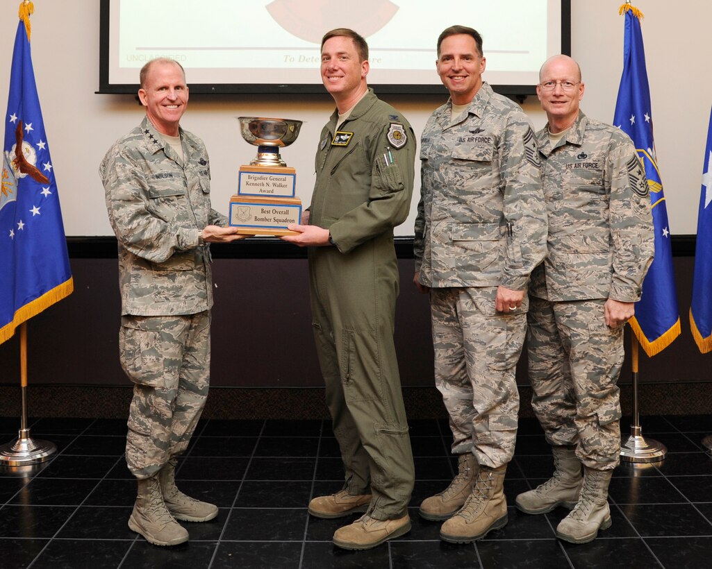 Lt. Gen. Stephen Wilson, Air Force Global Strike Command commander presents the Brigadier General Kenneth N. Walker Award for Best Overall Bomber Squadron to Col. Alexis Mezynski, 5th Bomb Wing commander during a ceremony at Barksdale Air Force Base, April 9. The award is presented annually to the wing recognized as the best in their field. (U.S. Air Force photo/Senior Airman Joseph A. Pagán Jr.)