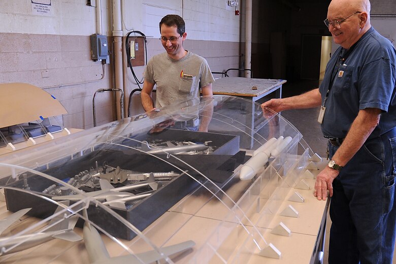 Museum Exhibit Specialists Caleb Still, and Jerry Miracle observe a 1:72 scale model aircraft layout at the National Museum of the U.S. Air Force.  These models are used to determine the exact aircraft layout for the museum’s fourth building by providing a three dimensional view.  The fourth building will house the Space, Presidential Aircraft, Research & Development  and Global Reach Galleries. (U.S. Air Force photo)